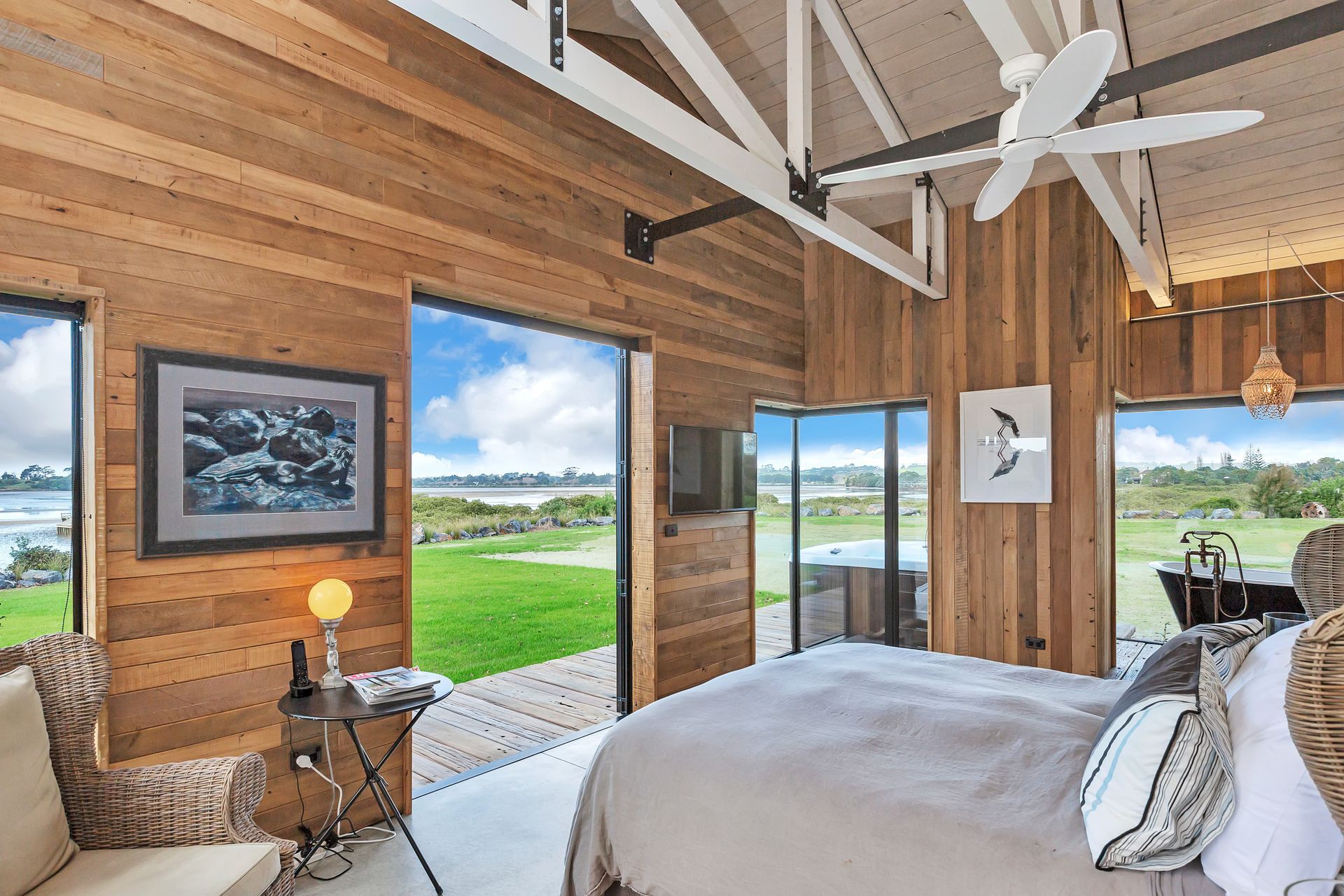 The master bedroom, en suite bath and spa enjoy views over the water.