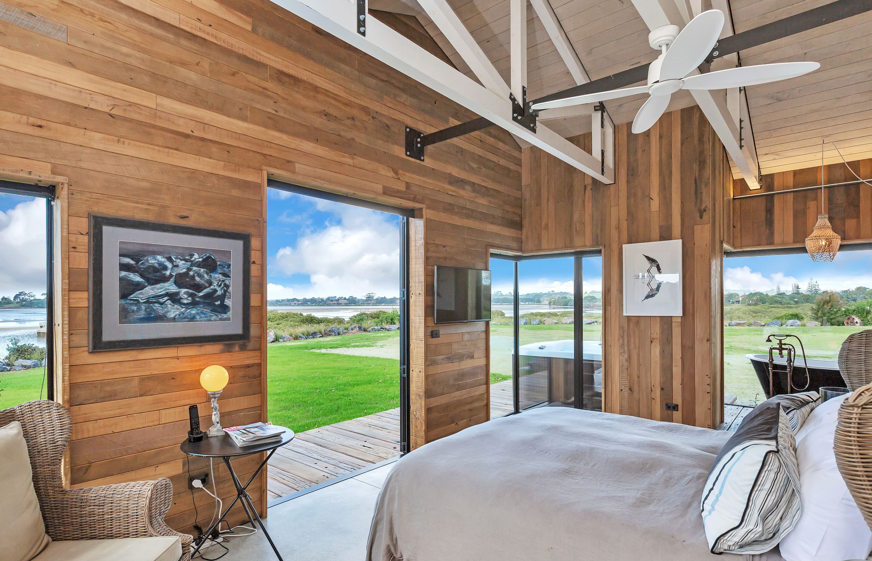The master bedroom, en suite bath and spa enjoy views over the water.