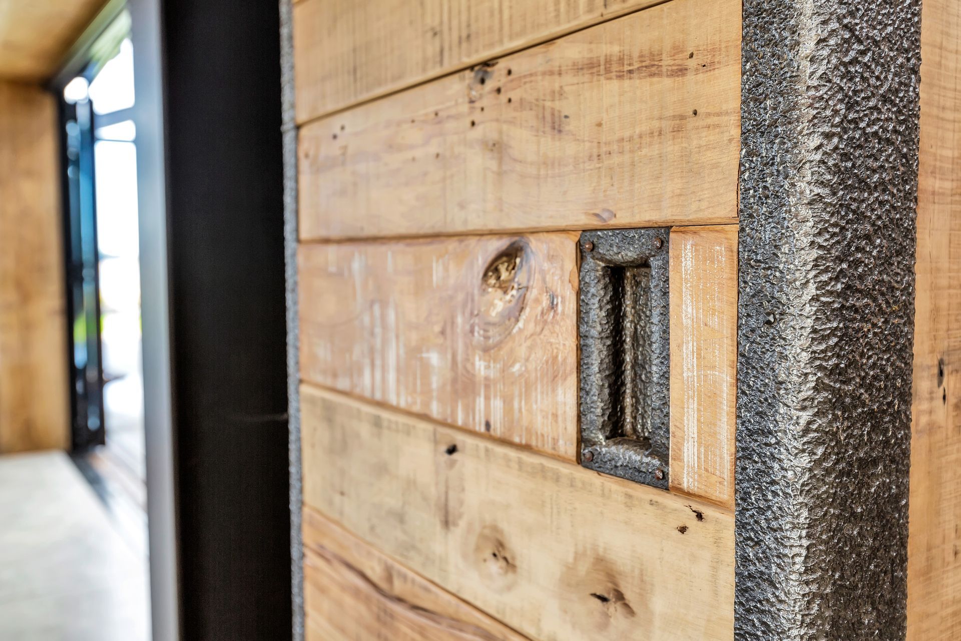 The sliding doors were handcrafted from recycled rimu floor joists from the Whitcoulls building in Wellington and the recycled inside of cyanide tanks from a Waihi goldmine.