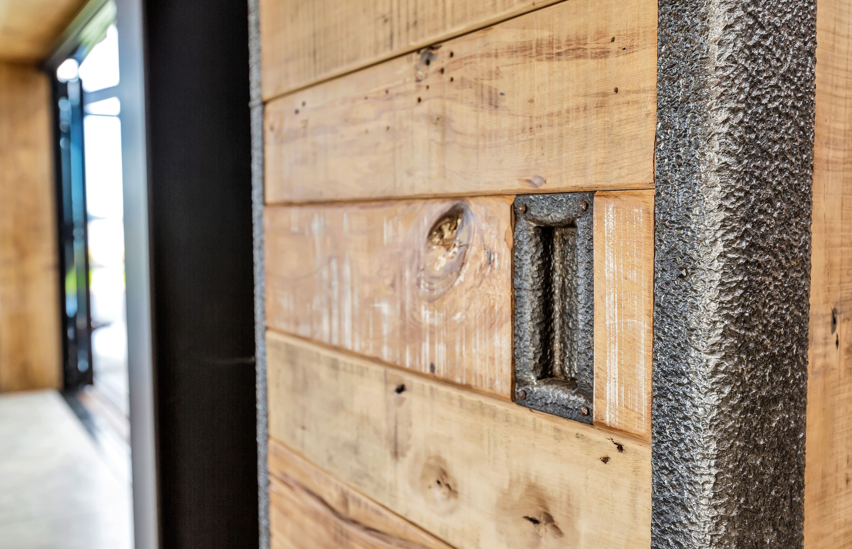 The sliding doors were handcrafted from recycled rimu floor joists from the Whitcoulls building in Wellington and the recycled inside of cyanide tanks from a Waihi goldmine.