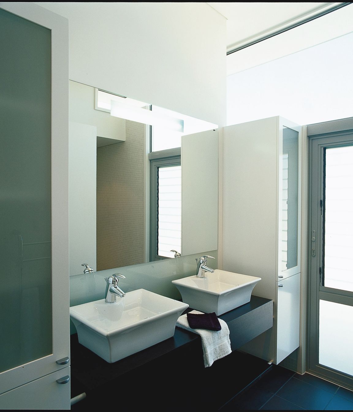 Ensuite Bathroom, mosaic tiled walk-in shower. High level glazing provides an abundance of light without compromising privacy.