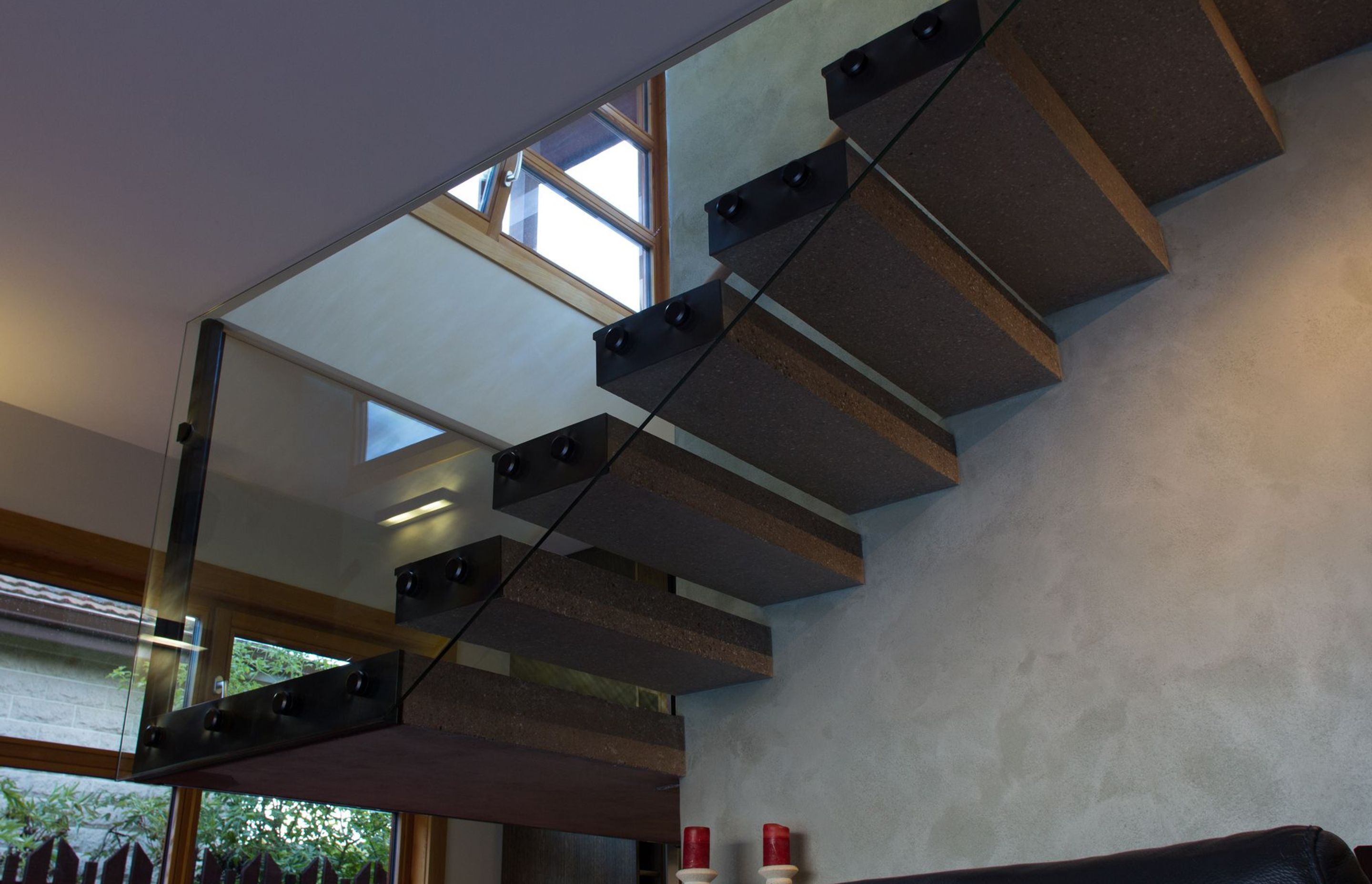 The concrete stairs 'float', hanging from the supporting wall.