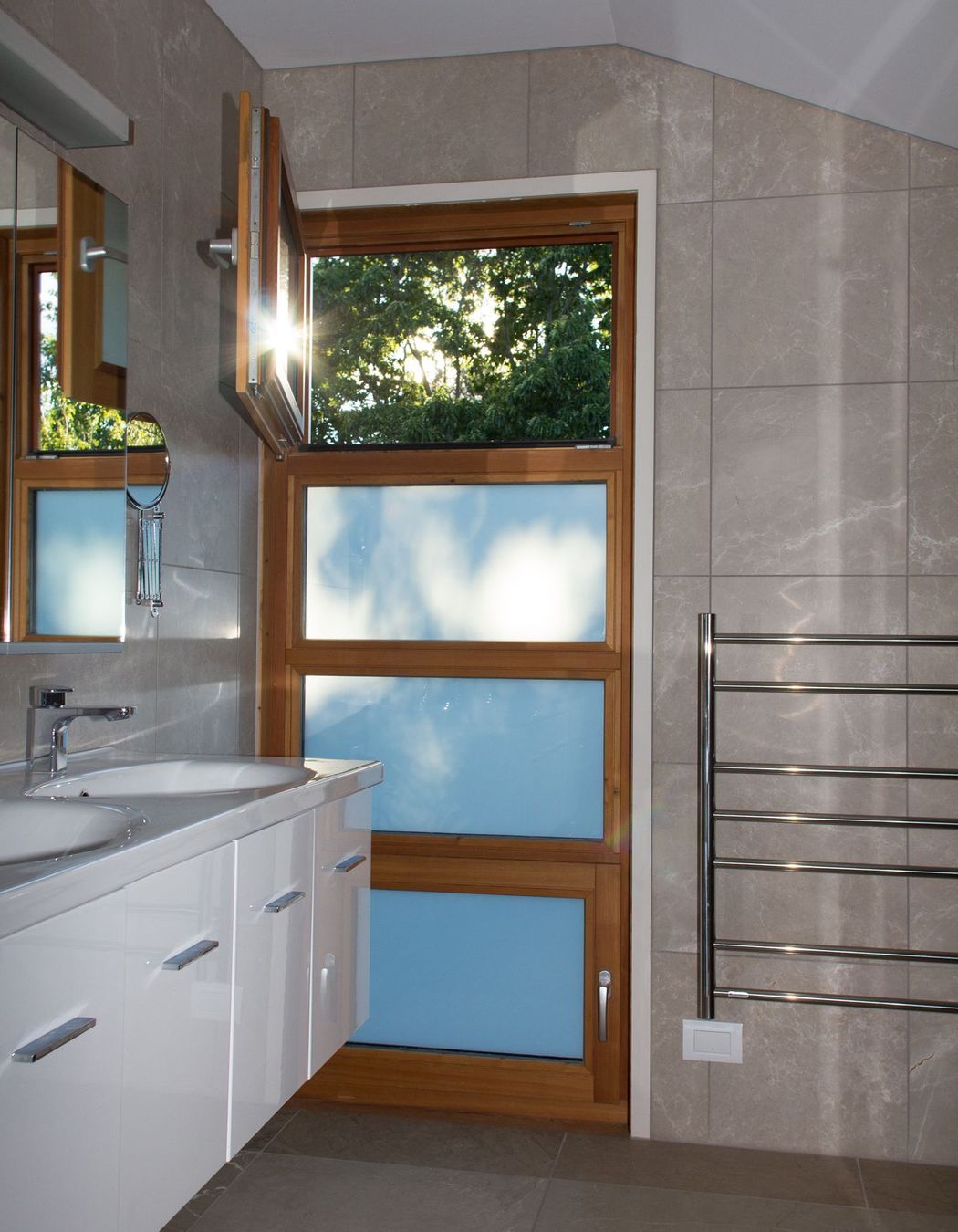 The morning sun casts interesting shadows on this bathroom window.