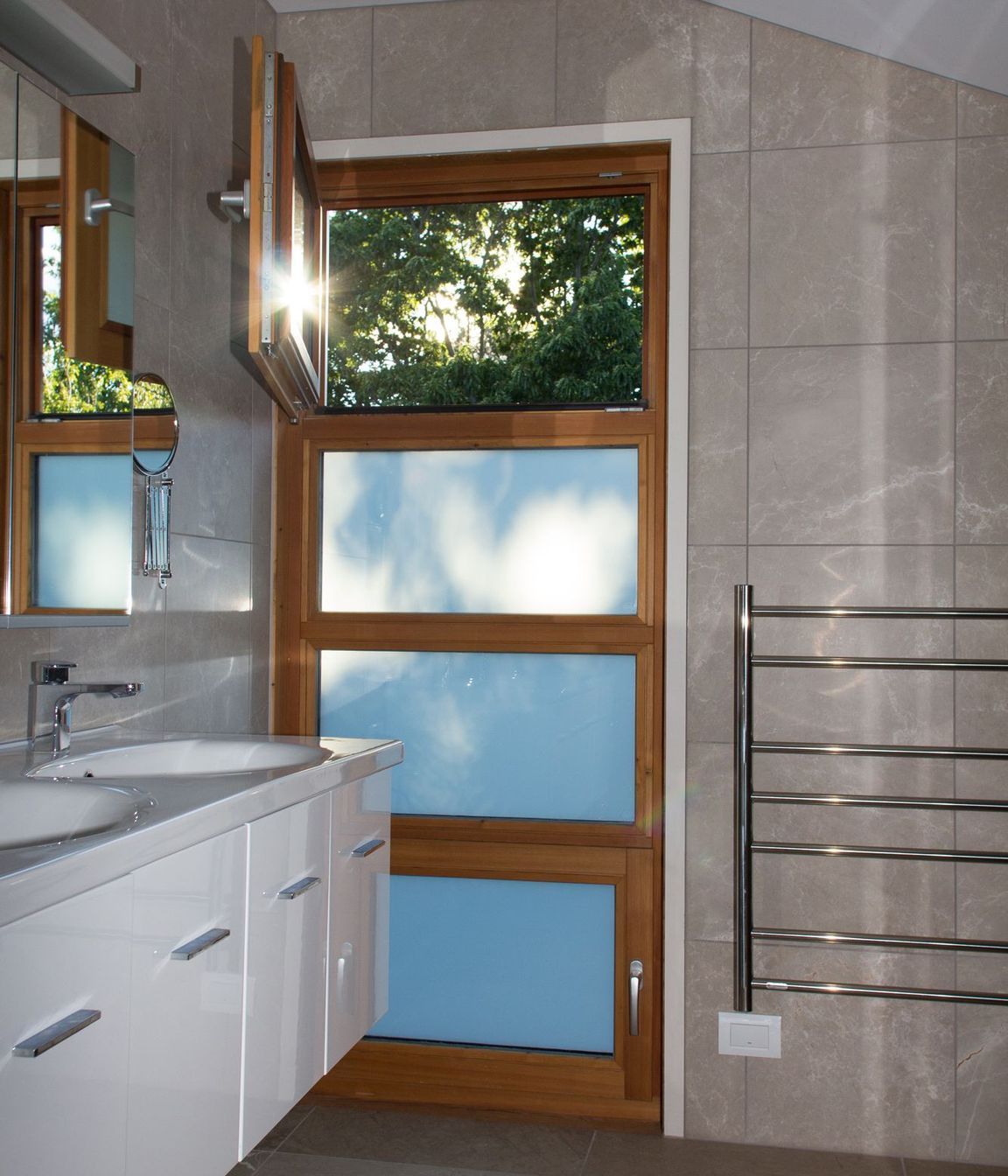 The morning sun casts interesting shadows on this bathroom window.
