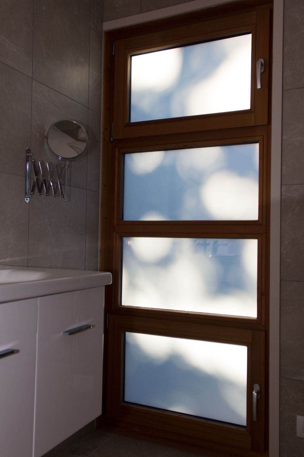 The morning sun casts interesting shadows on this bathroom window.