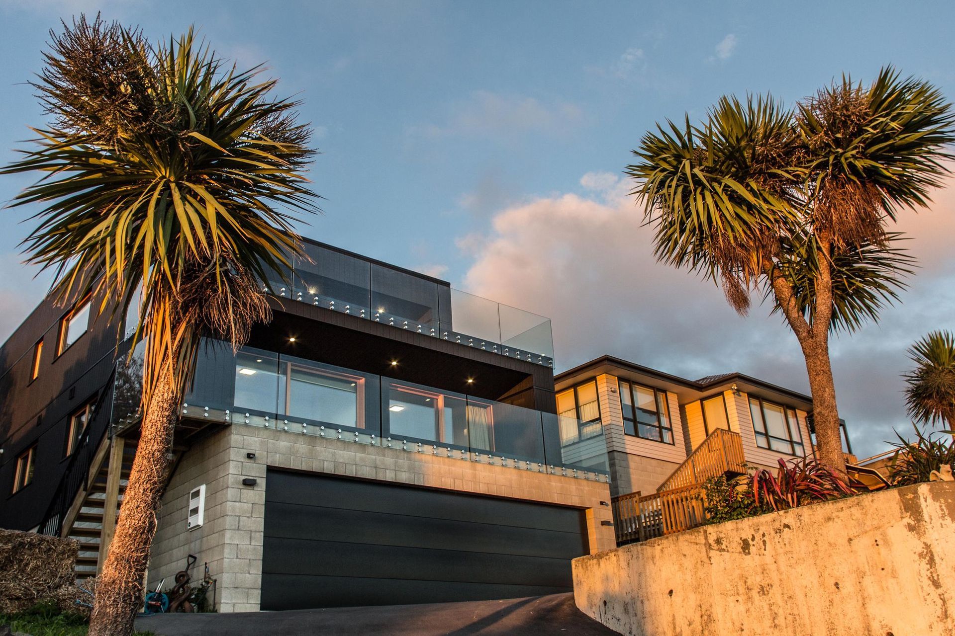The home is formed by a series of simple blocks cascading down the steep hill site.