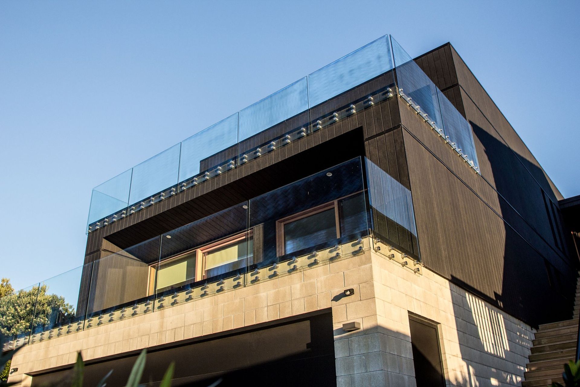 The home is formed by a series of simple blocks cascading down the steep hill site.
