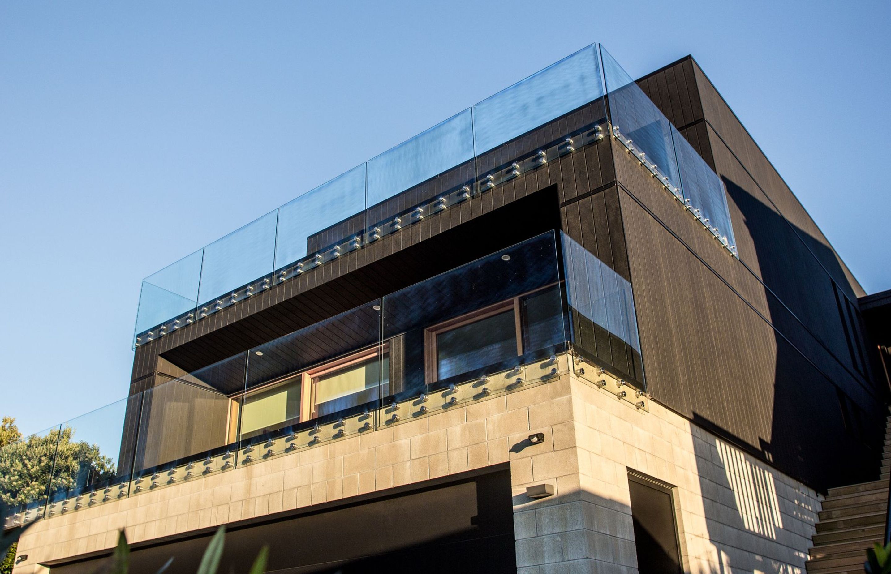 The home is formed by a series of simple blocks cascading down the steep hill site.