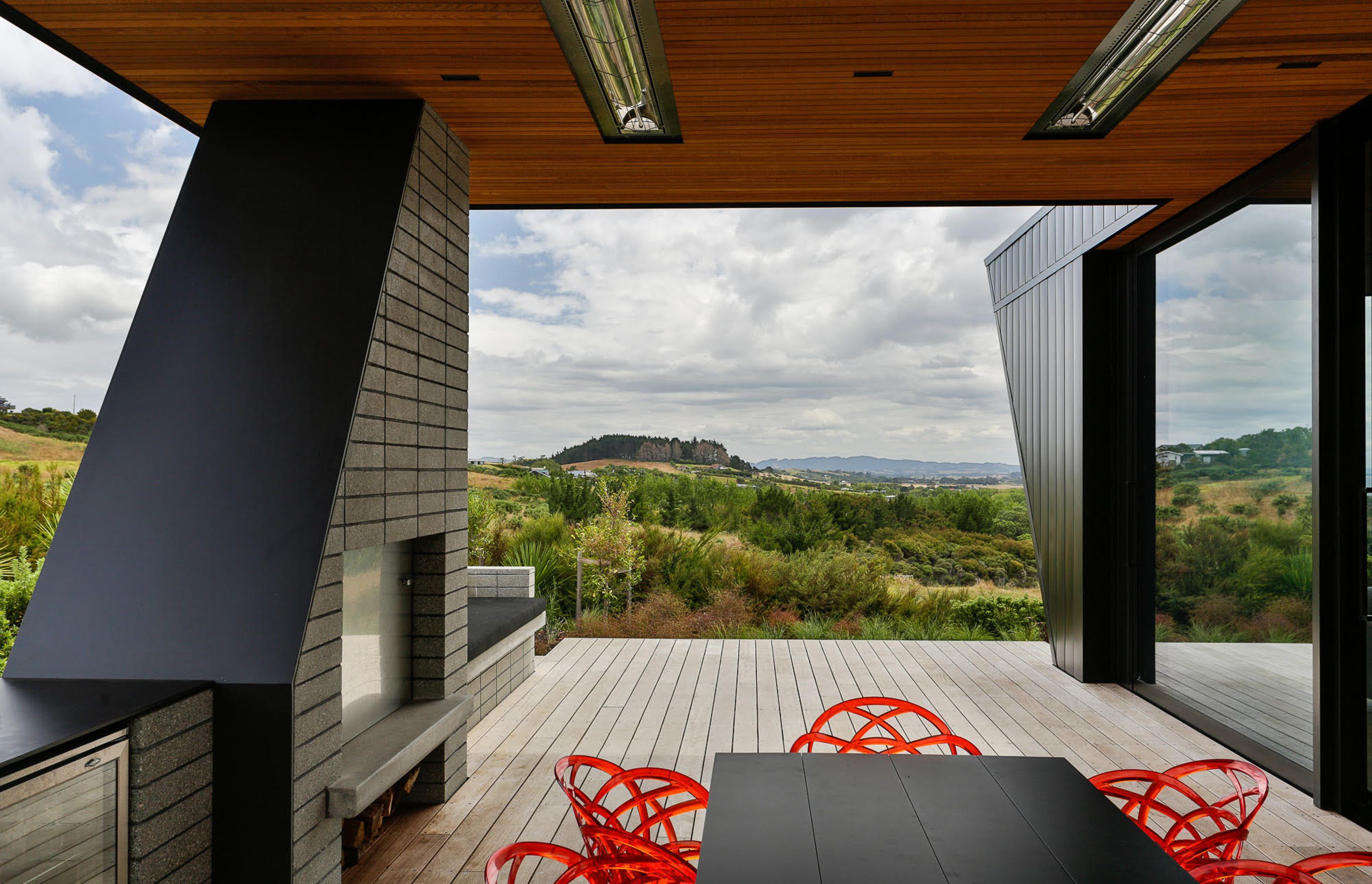 The southeast facing sheltered outdoor space is heralded by an outdoor fire and kitchen.