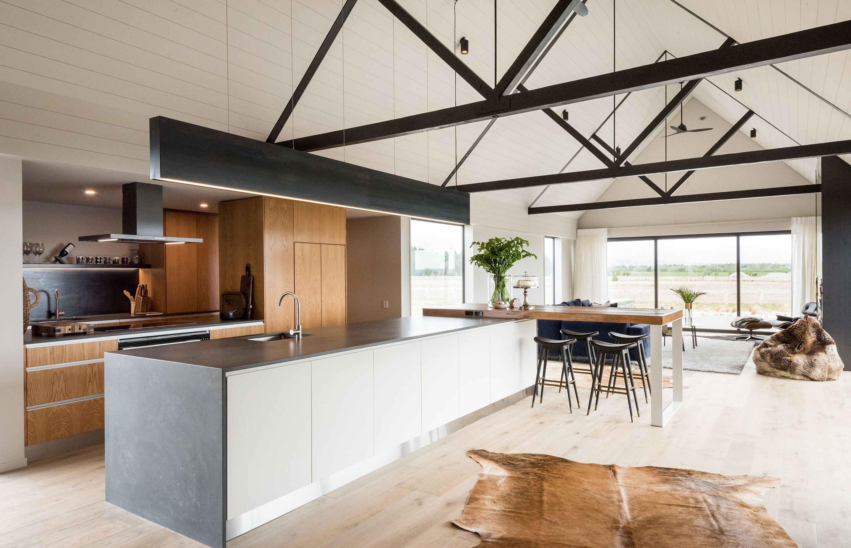 Main pavilion area with a gabled ceiling, framed by impressive timber trusses