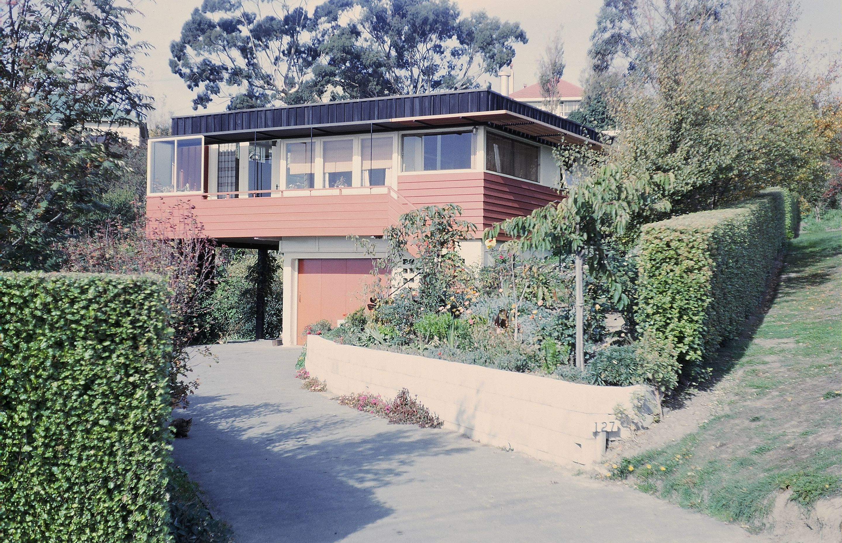 The original house again several years later with partially enclosed balcony and covered addition.