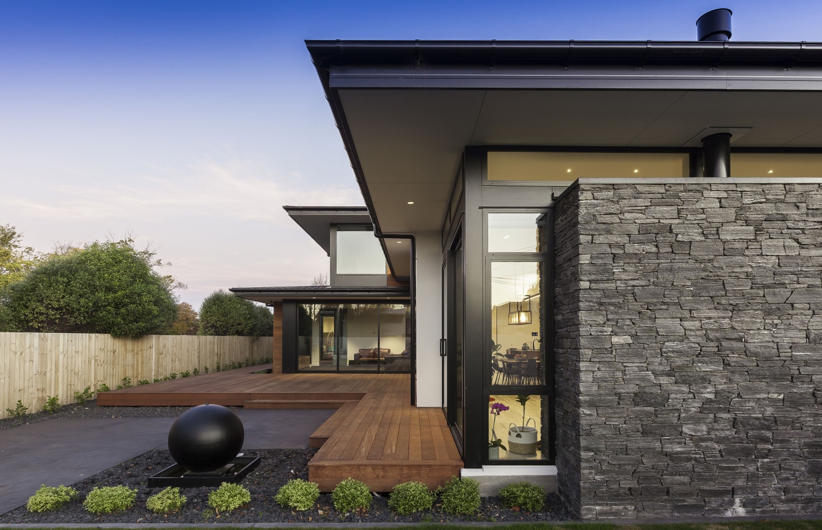 An exterior palette of schist, cedar weatherboards, plaster and kwila decking impart a modern feel and complement the bold architectural lines.