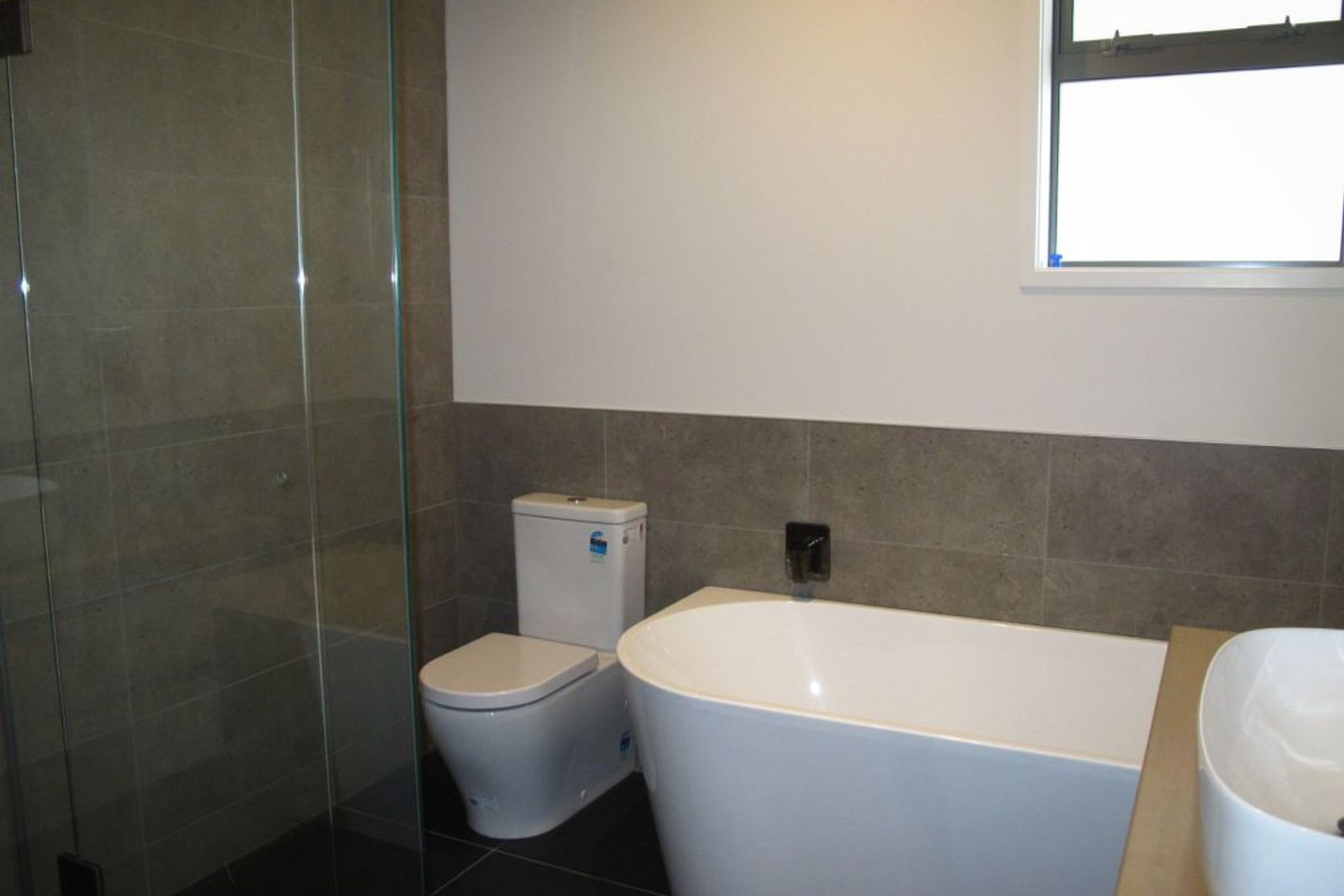 The main bathroom with tiled shower in a new residential build