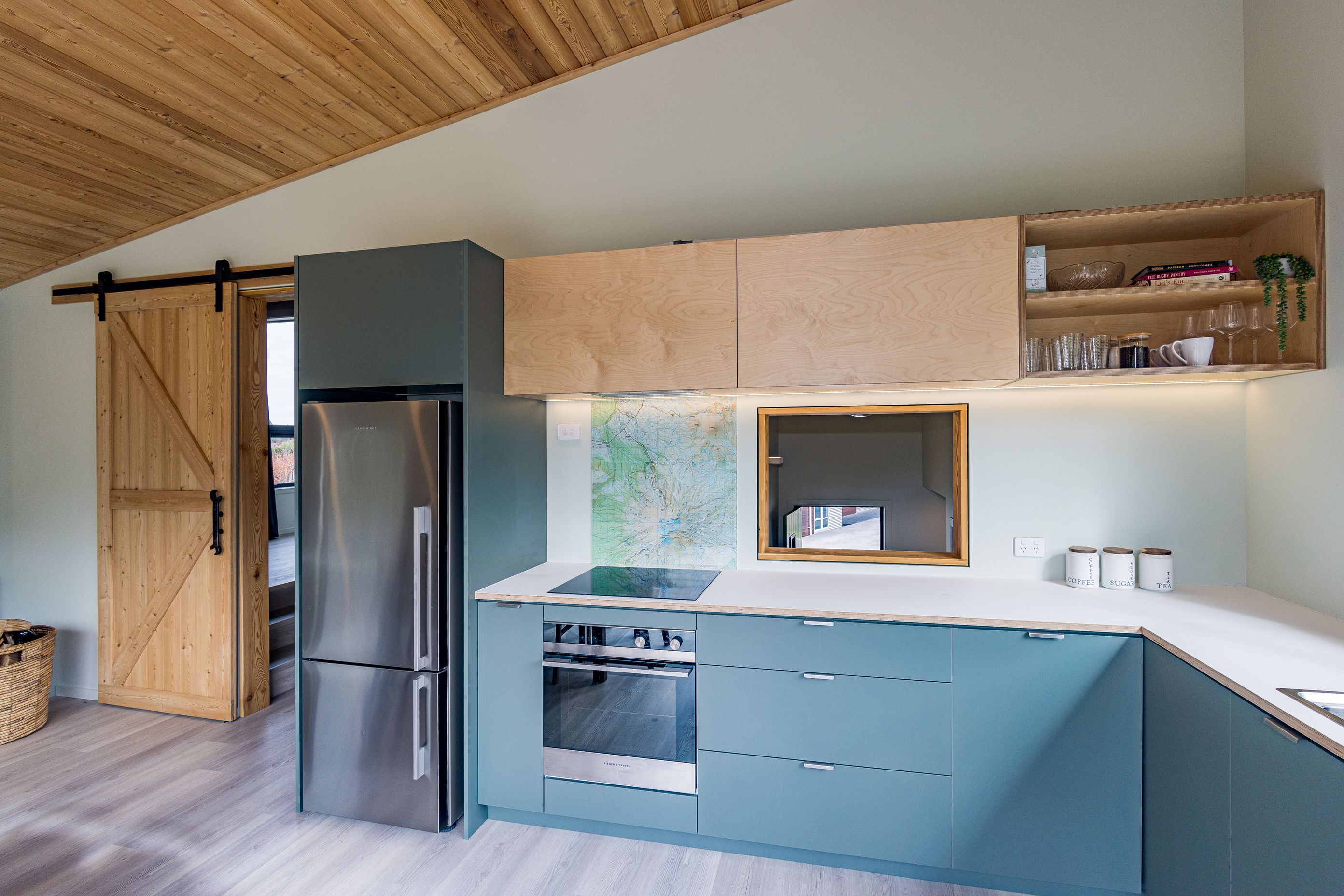 Timber is used throughout as a feature – here, cabinetry, ceiling and barn door.