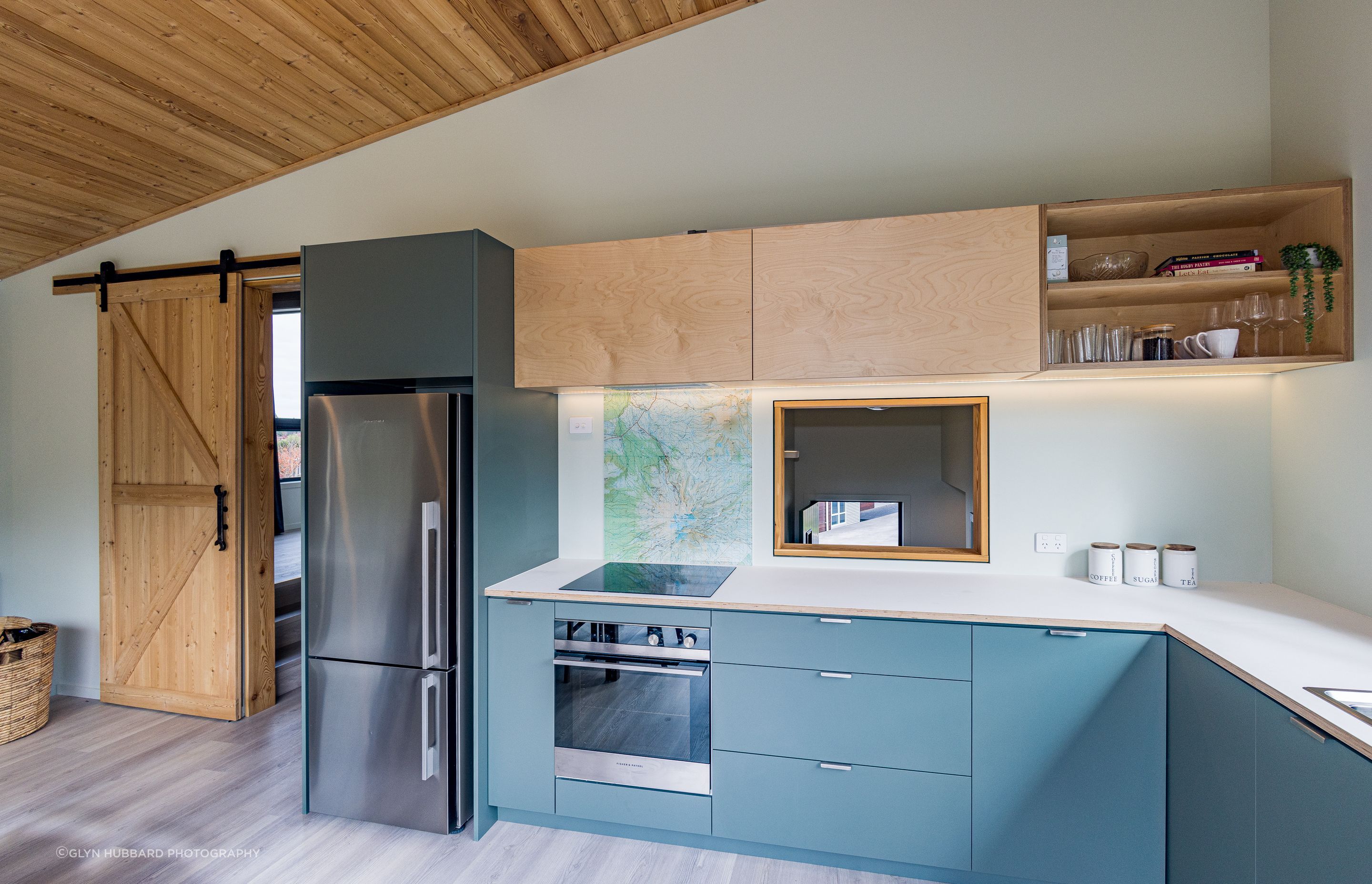 Timber is used throughout as a feature – here, cabinetry, ceiling and barn door.