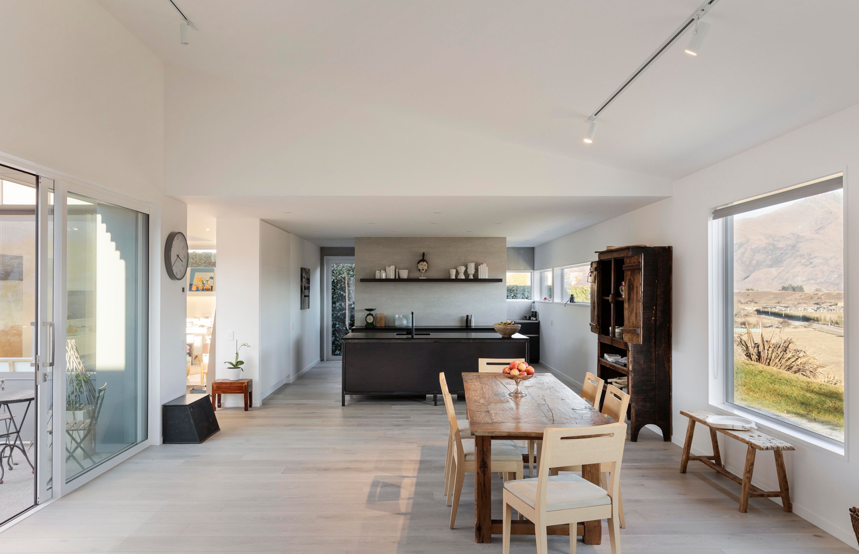 The kitchen hides a scullery behind it, removing clutter from the open-plan kitchen/dining space.