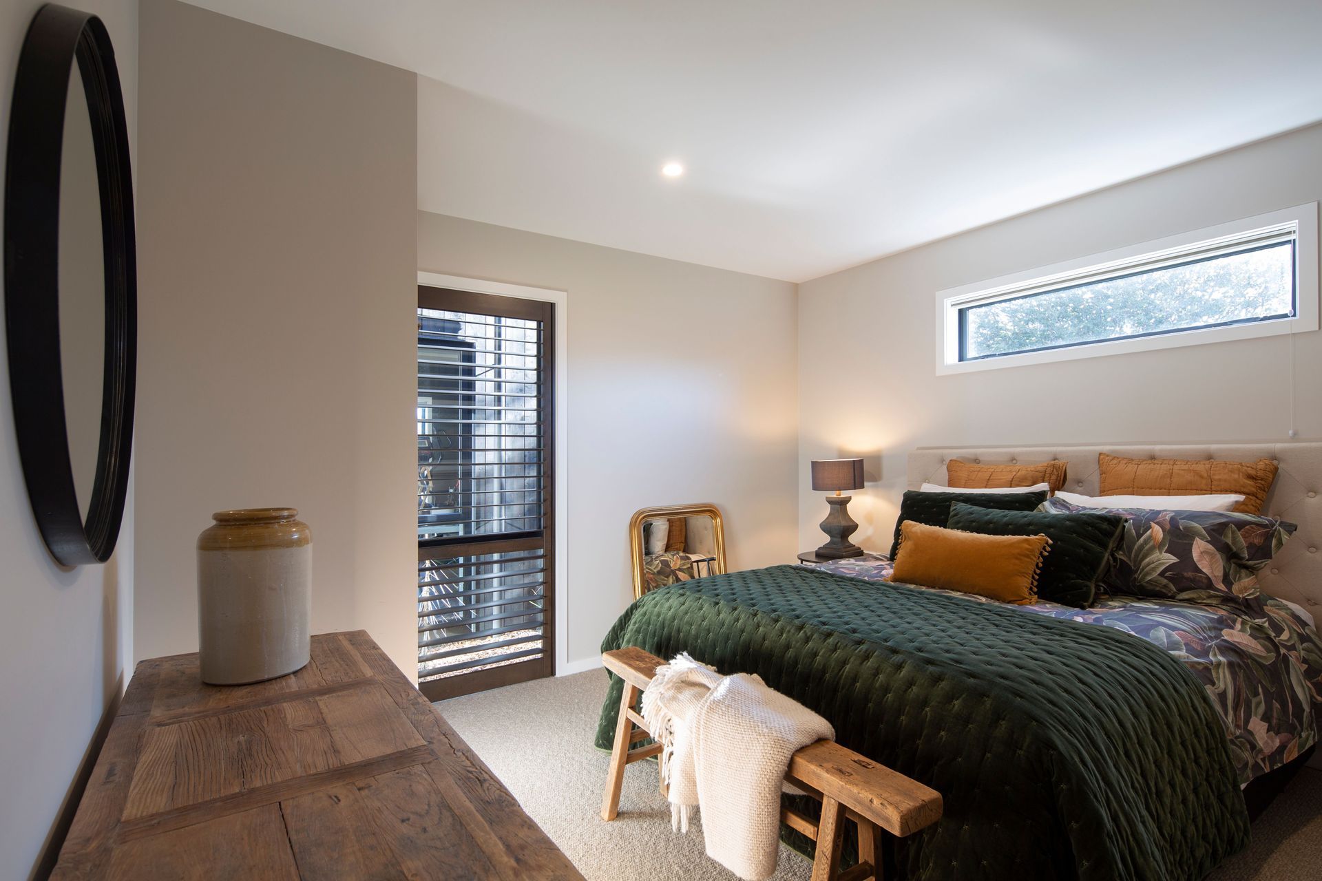 The alpine lodge aesthetic continues through to the guest bedroom.