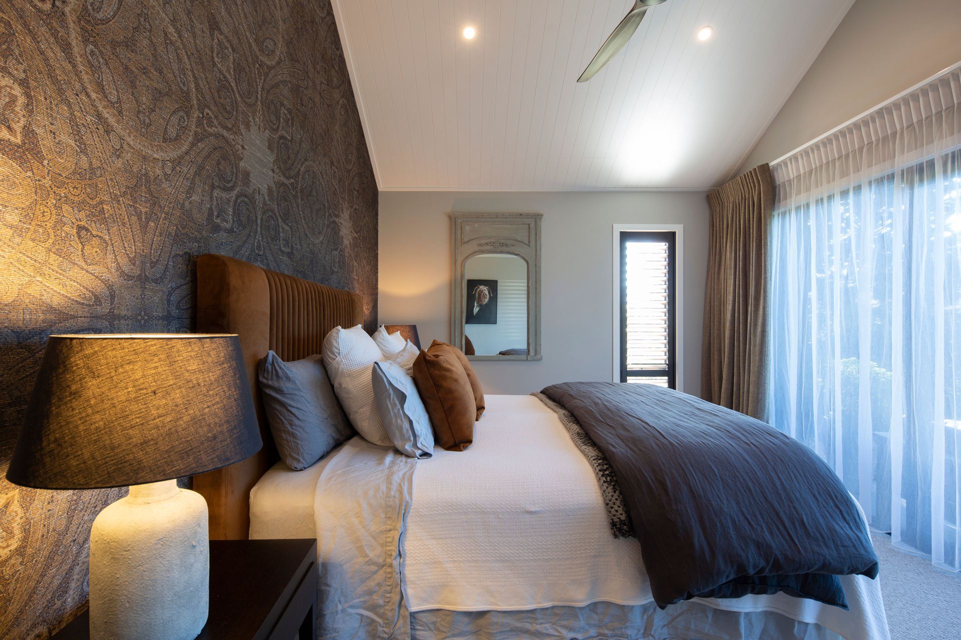 Home owners chose Elwick Paisley wallpaper by Zoffany as a backdrop to their bed and the Vernara Copper headboard by Bianca Lorenne also makes a statement.