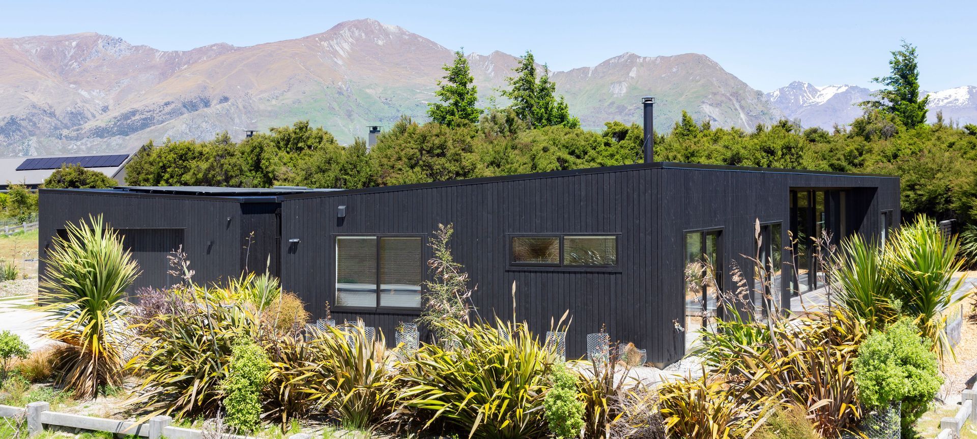 A jet-black mountain home protected by CUTEK® Extreme Oil banner