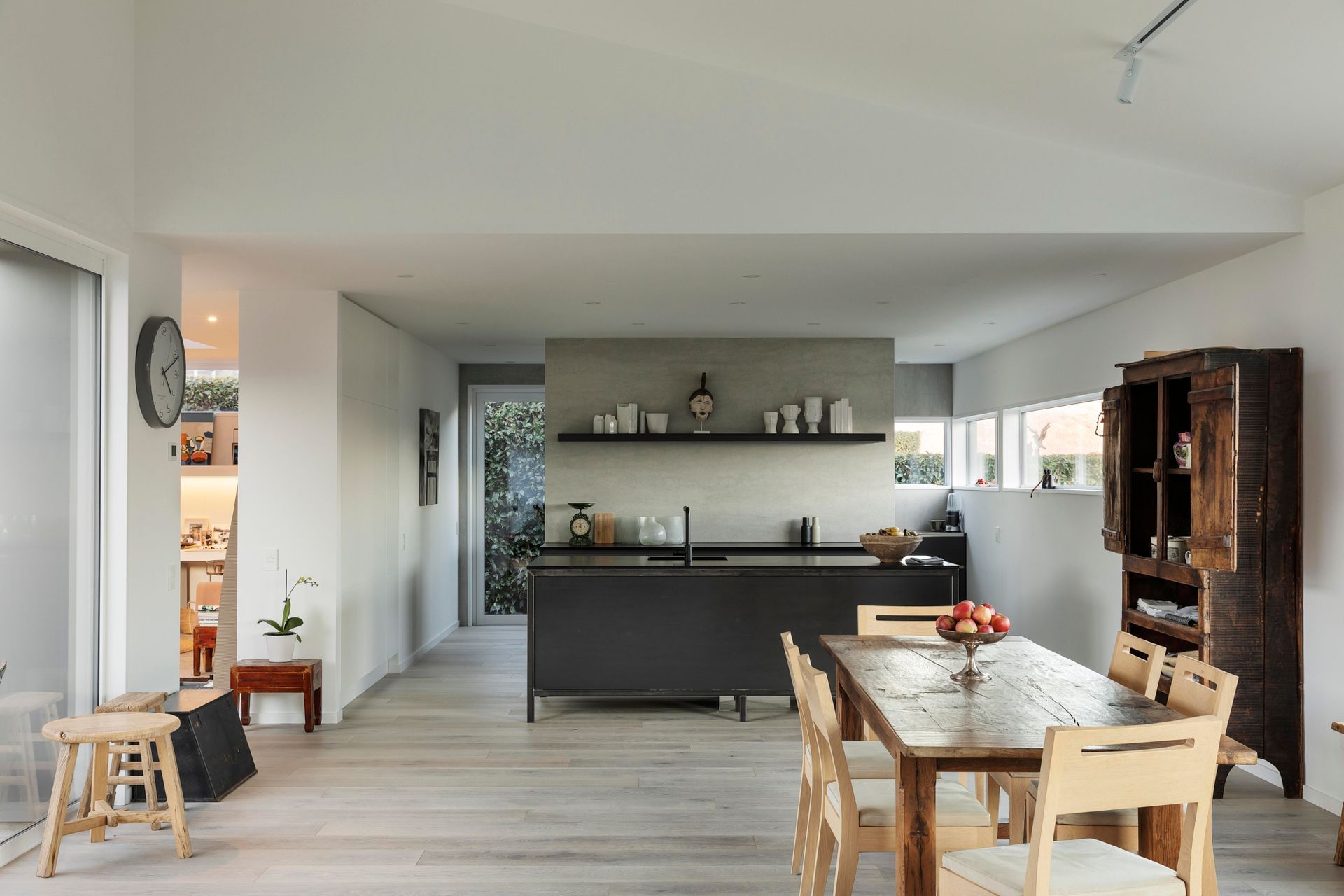 The pale floors and white walls of the interior provide the perfect backdrop for tasteful furniture and art.
