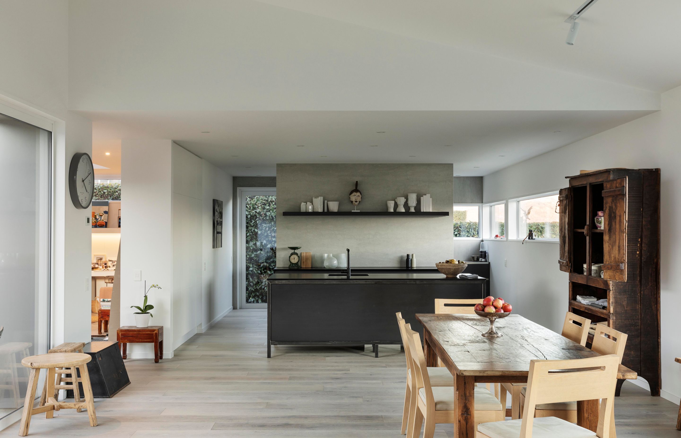 The pale floors and white walls of the interior provide the perfect backdrop for tasteful furniture and art.