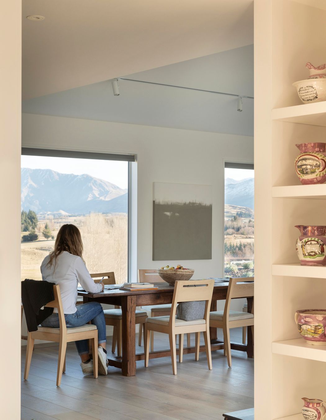 Jane's daughter sitting at the kitchen table, with the stunning views in the backdrop.