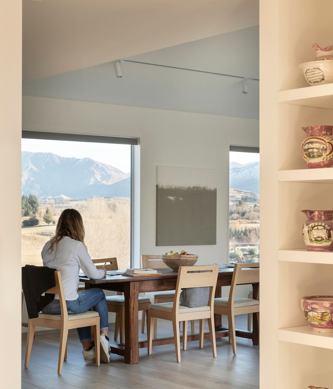 Jane's daughter sitting at the kitchen table, with the stunning views in the backdrop.