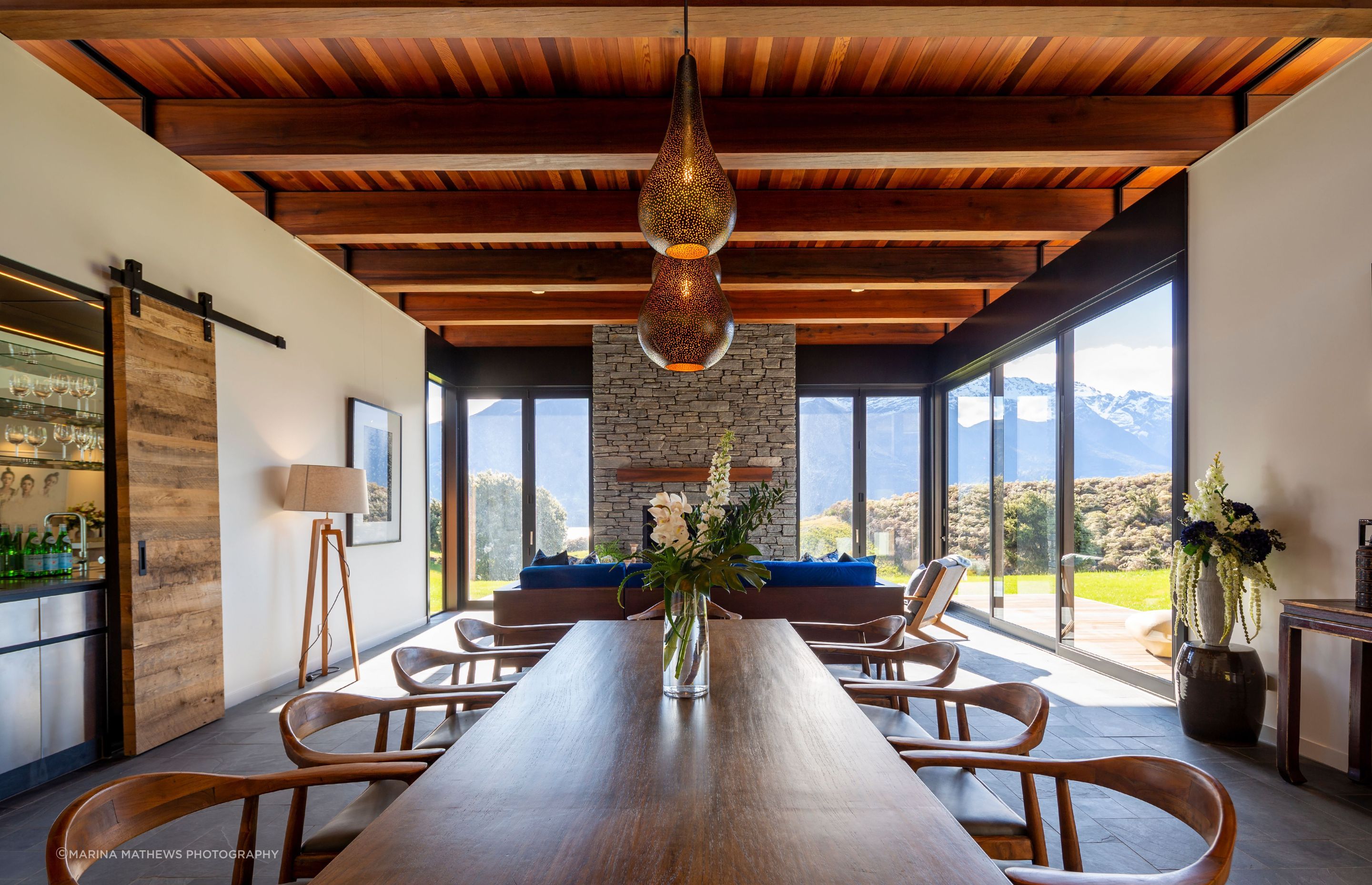 The fireplace is clad in schist stone, following in from the exterior.