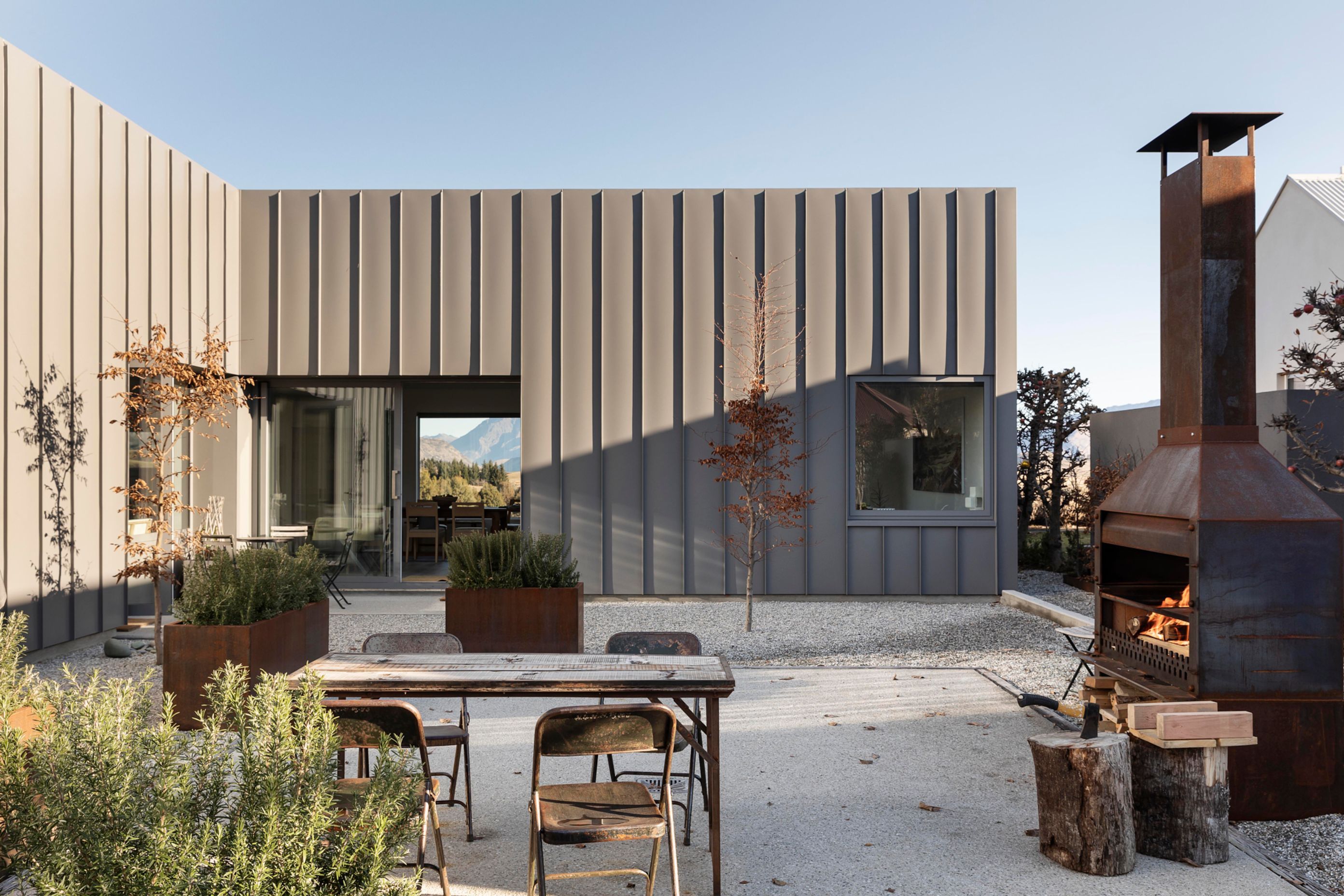 The muted grey Euro tray profile of the exterior blends seamlessly with the subdued hues of the external courtyard.