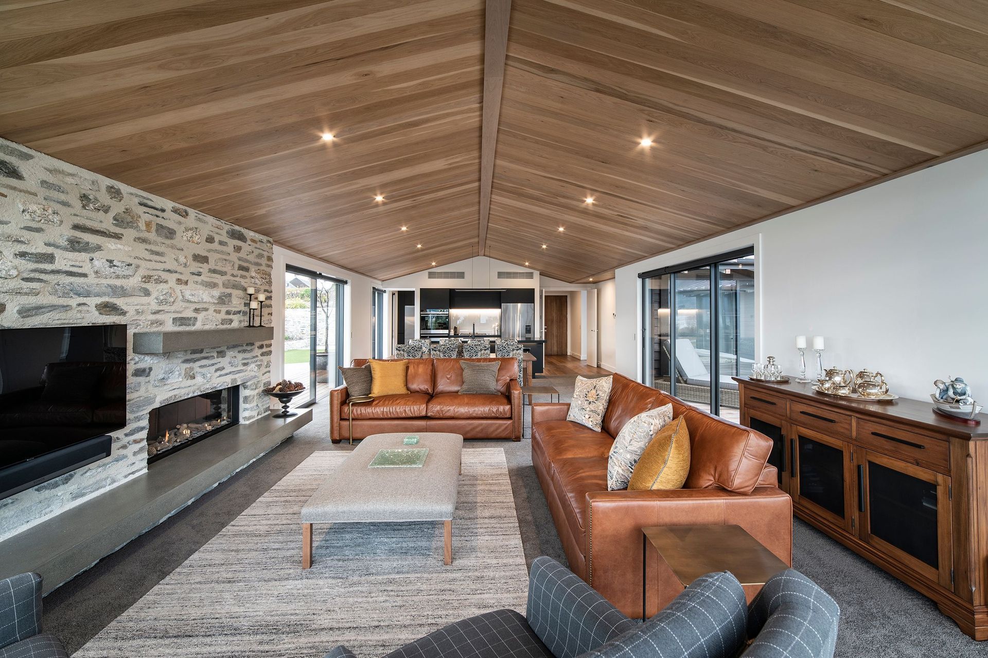 The main living area is contained within one of the two pavilion-style structures that make up the public and private spaces of the home. Off either side of the living area are multiple outdoor zones for further entertaining.
