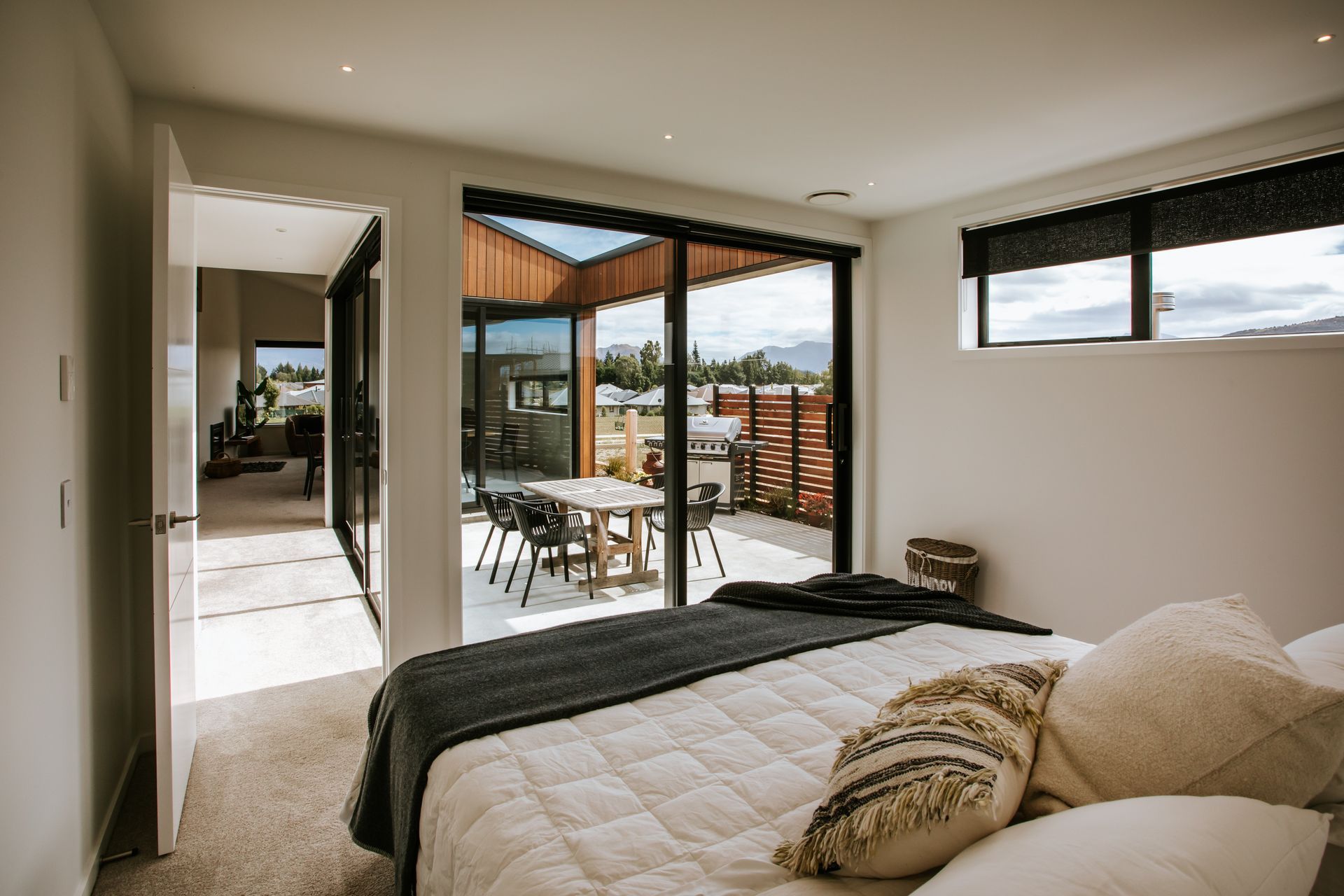 A cosy and comfortable bedroom looks out onto the external courtyard.