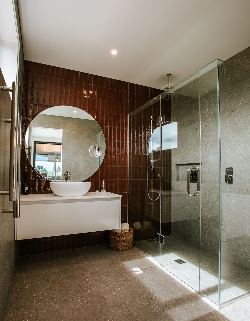 The fully tiled bathroom is a luxurious and sleek haven.