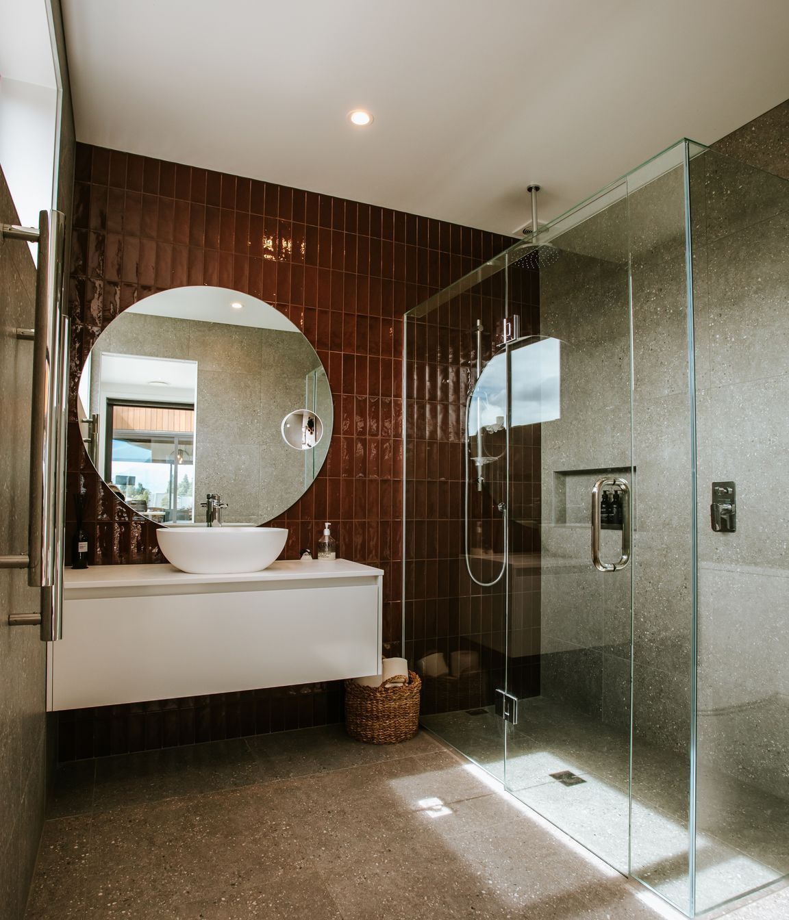 The fully tiled bathroom is a luxurious and sleek haven.