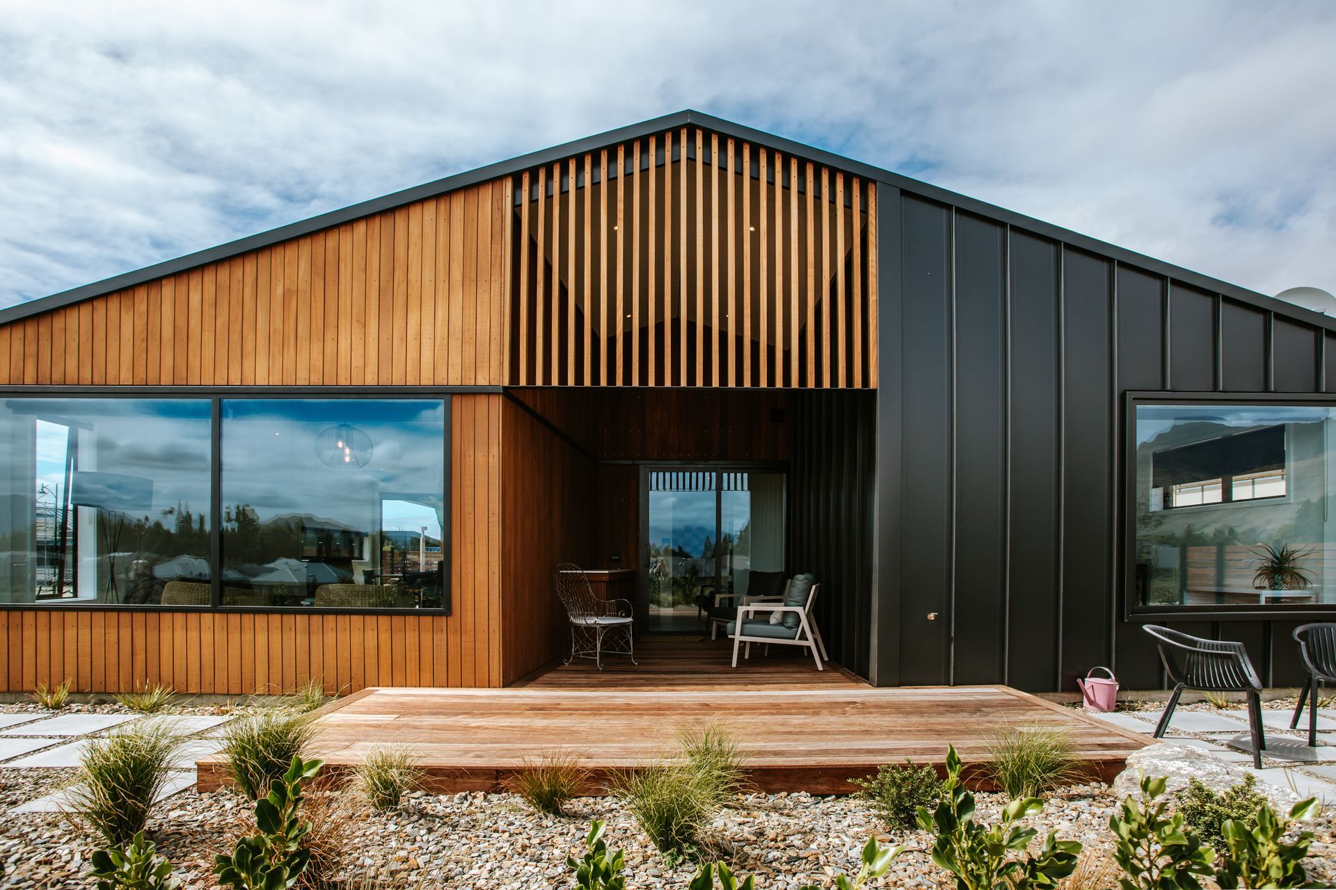 The back of the home juxtaposes dark tray cladding against warm timber cladding.