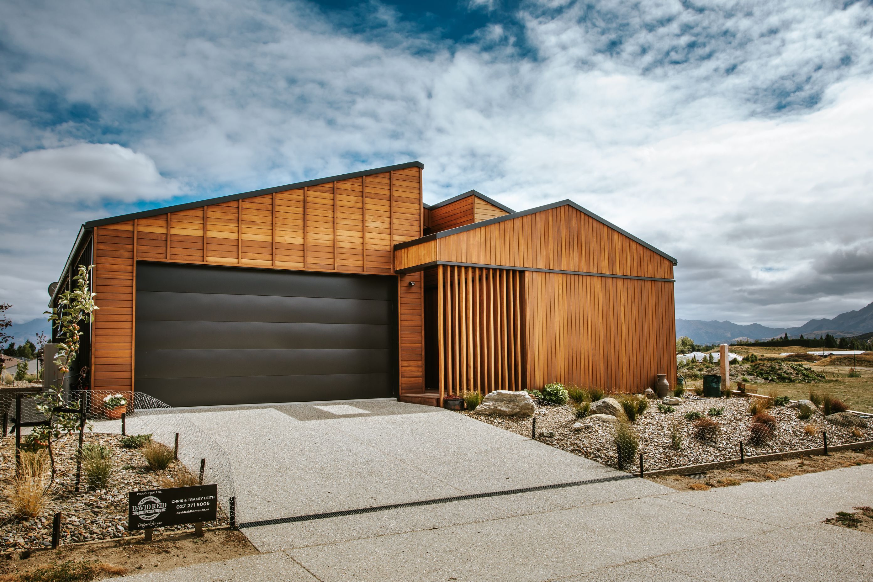 The road-facing elevation features Truwood cladding in varying horizontal, vertical and battened formations.