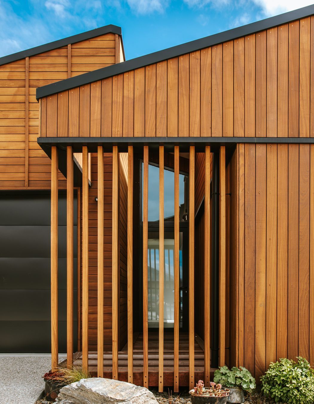 The front entry features screening in Truwood to create privacy for the glazed front entry door.
