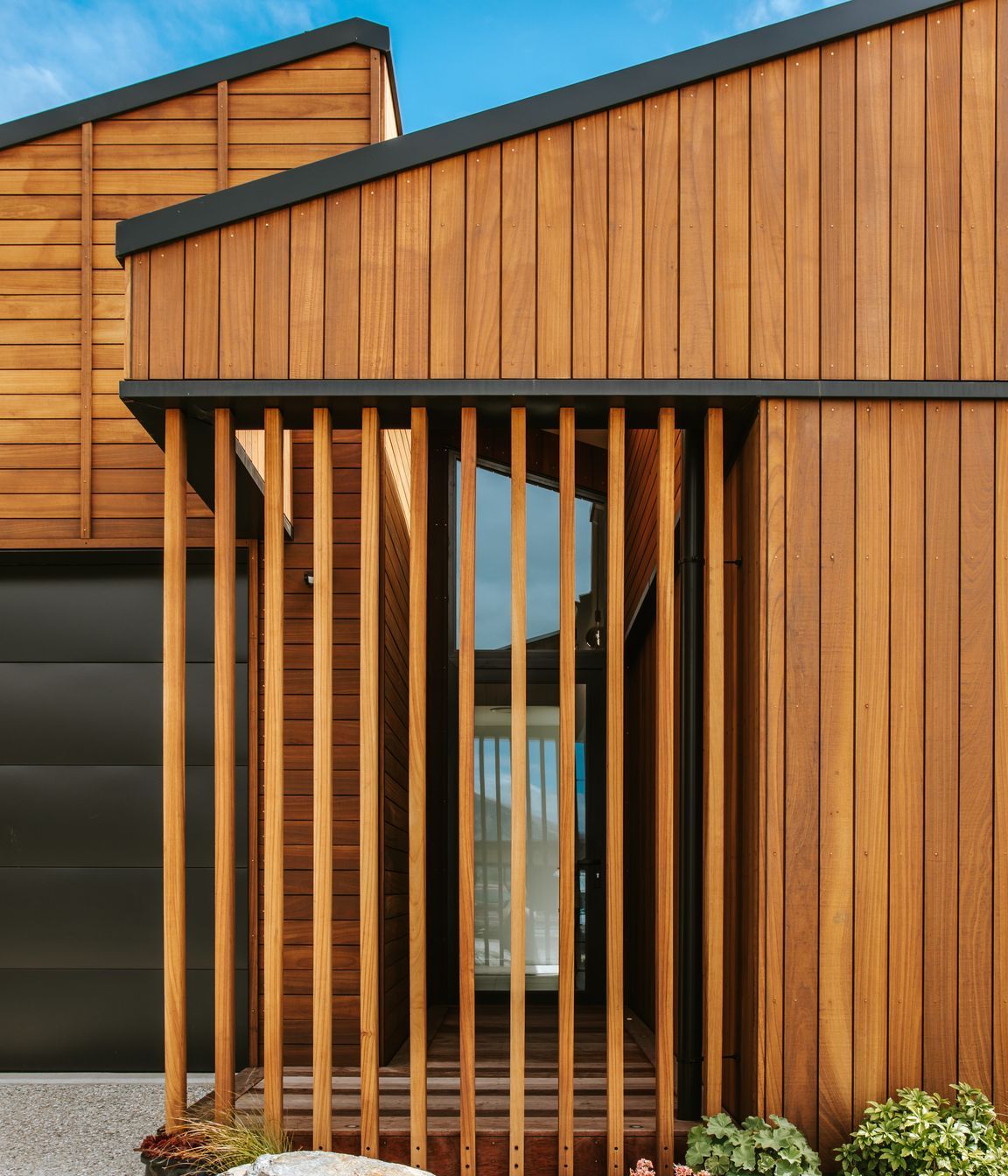 The front entry features screening in Truwood to create privacy for the glazed front entry door.