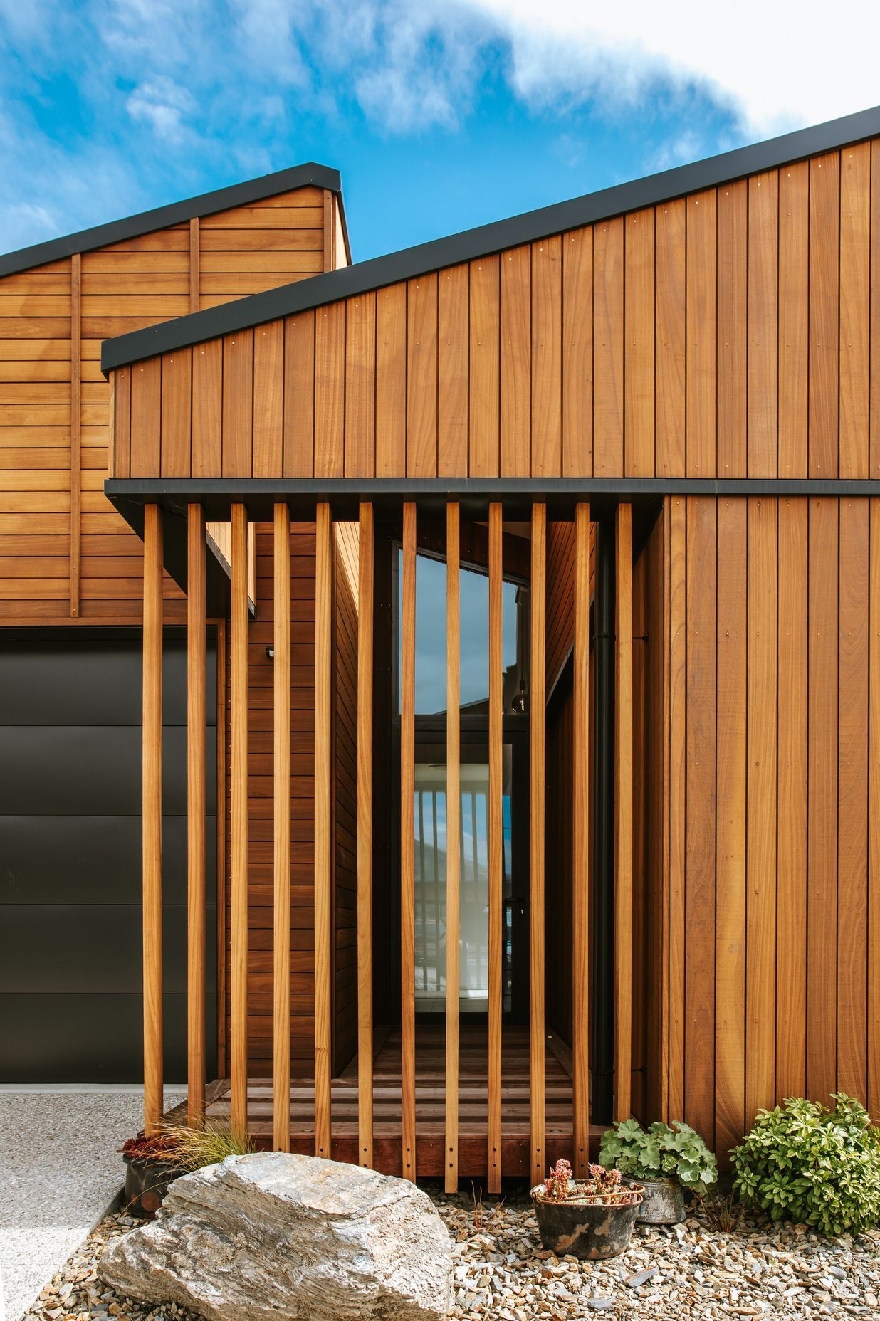 The front entry features screening in Truwood to create privacy for the glazed front entry door.