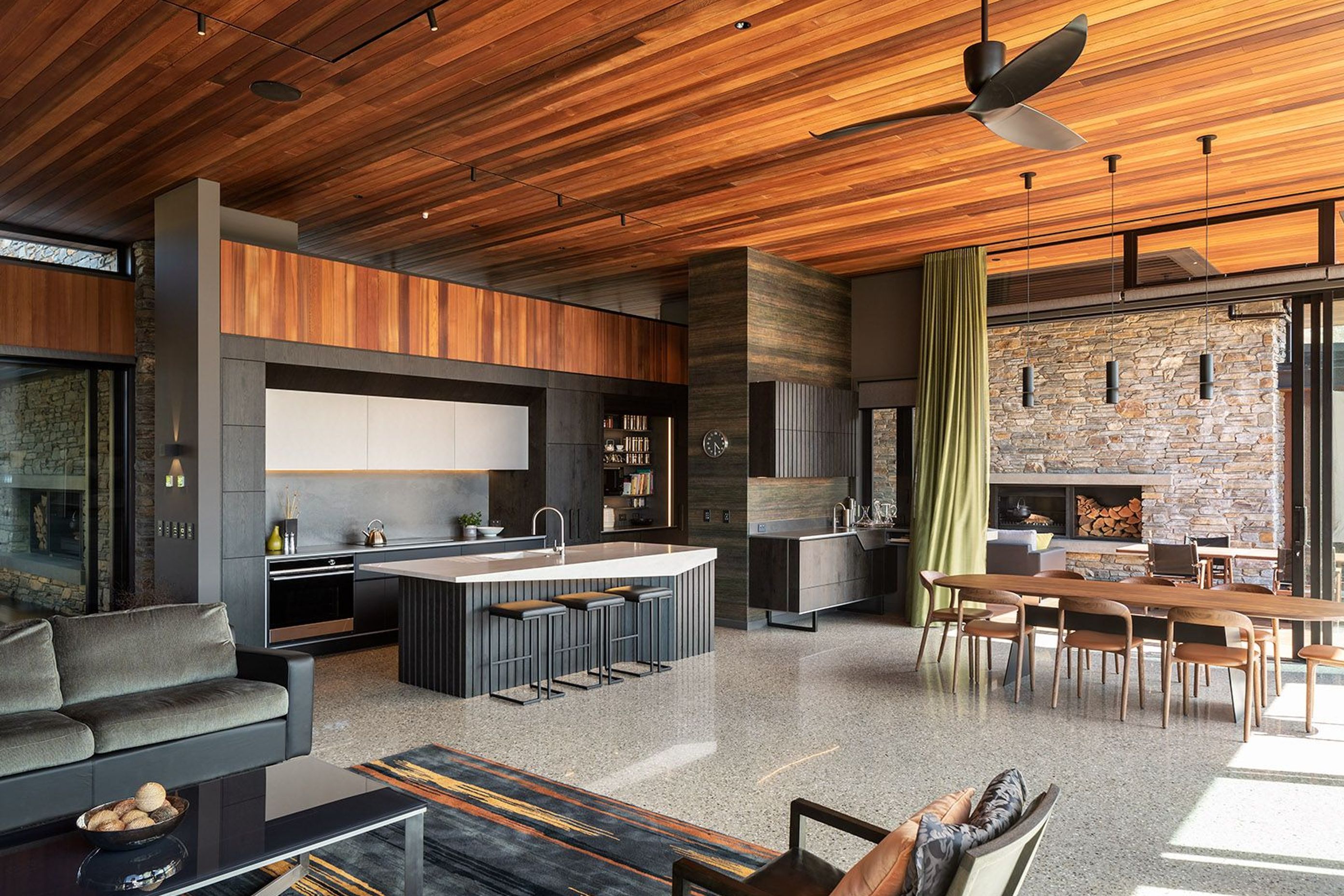 The schist outdoor chimneys can be seen from the interior, and integrate nicely with the cedar ceiling lining.