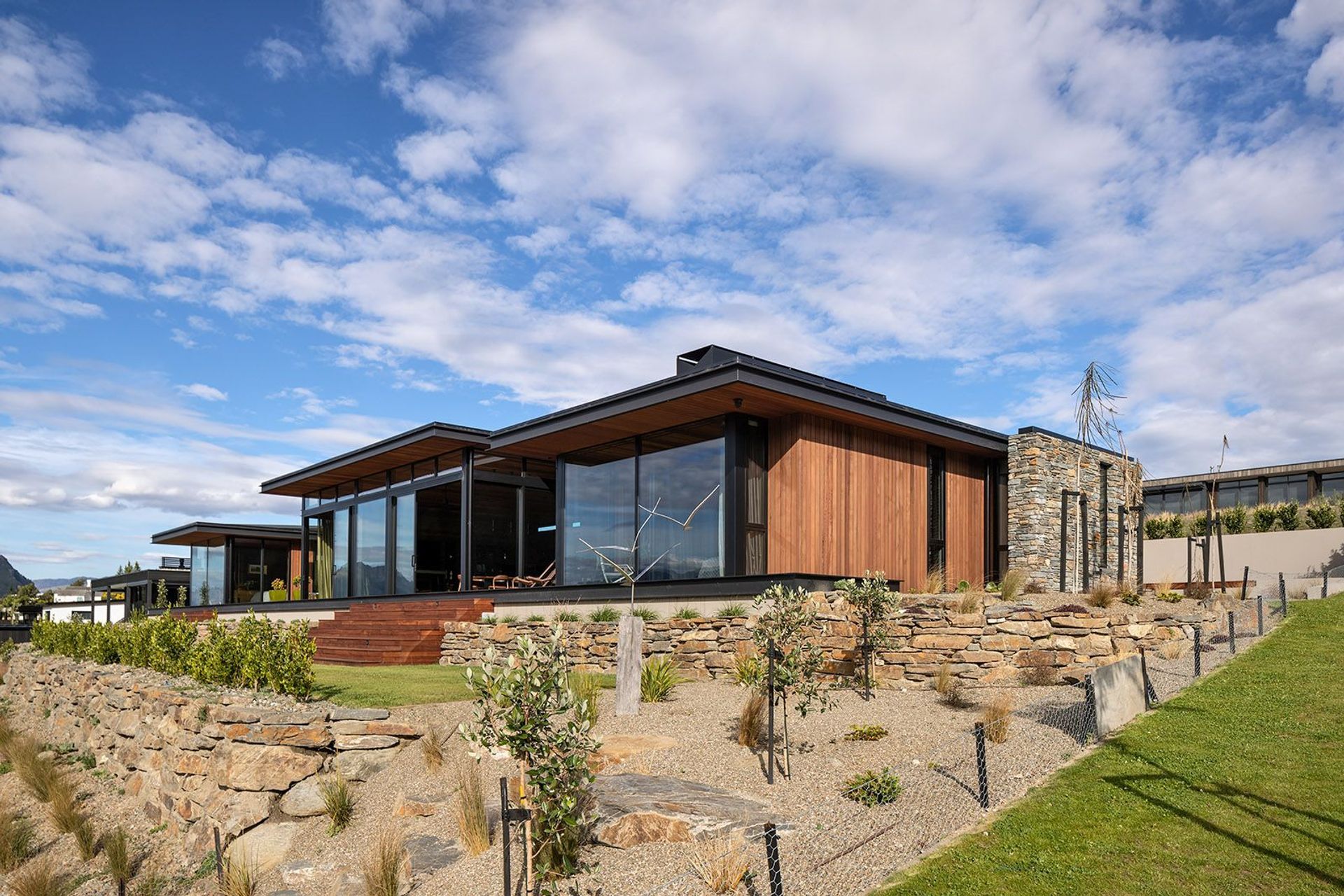 Stone retaining walls integrate the home into the landscape.