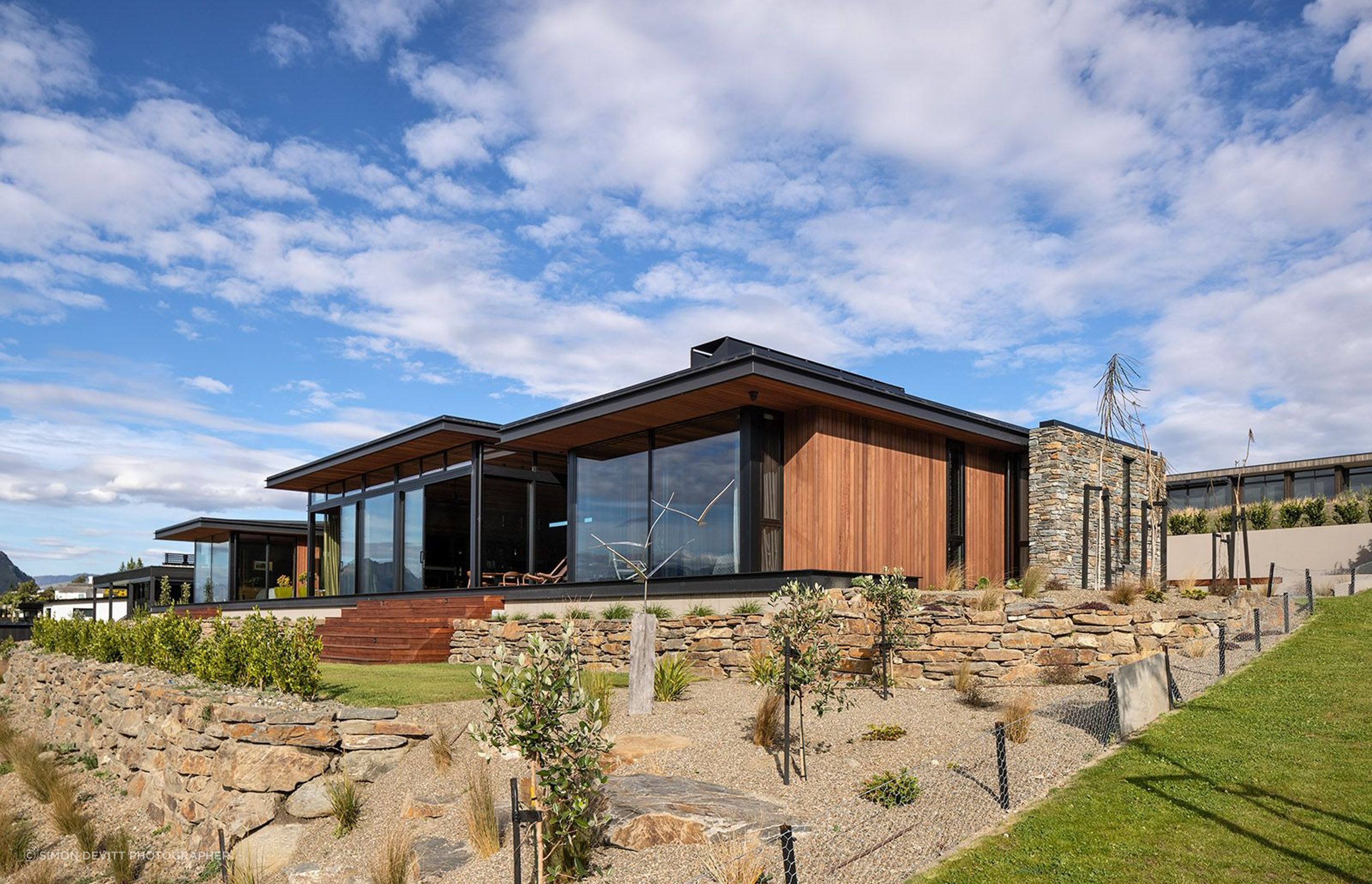 Stone retaining walls integrate the home into the landscape.