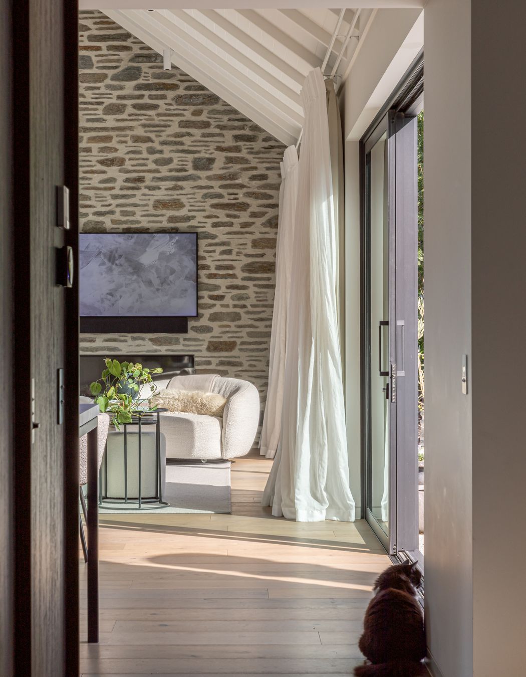 Schist stone ant timber plank flooring add warmth and texture to the interior