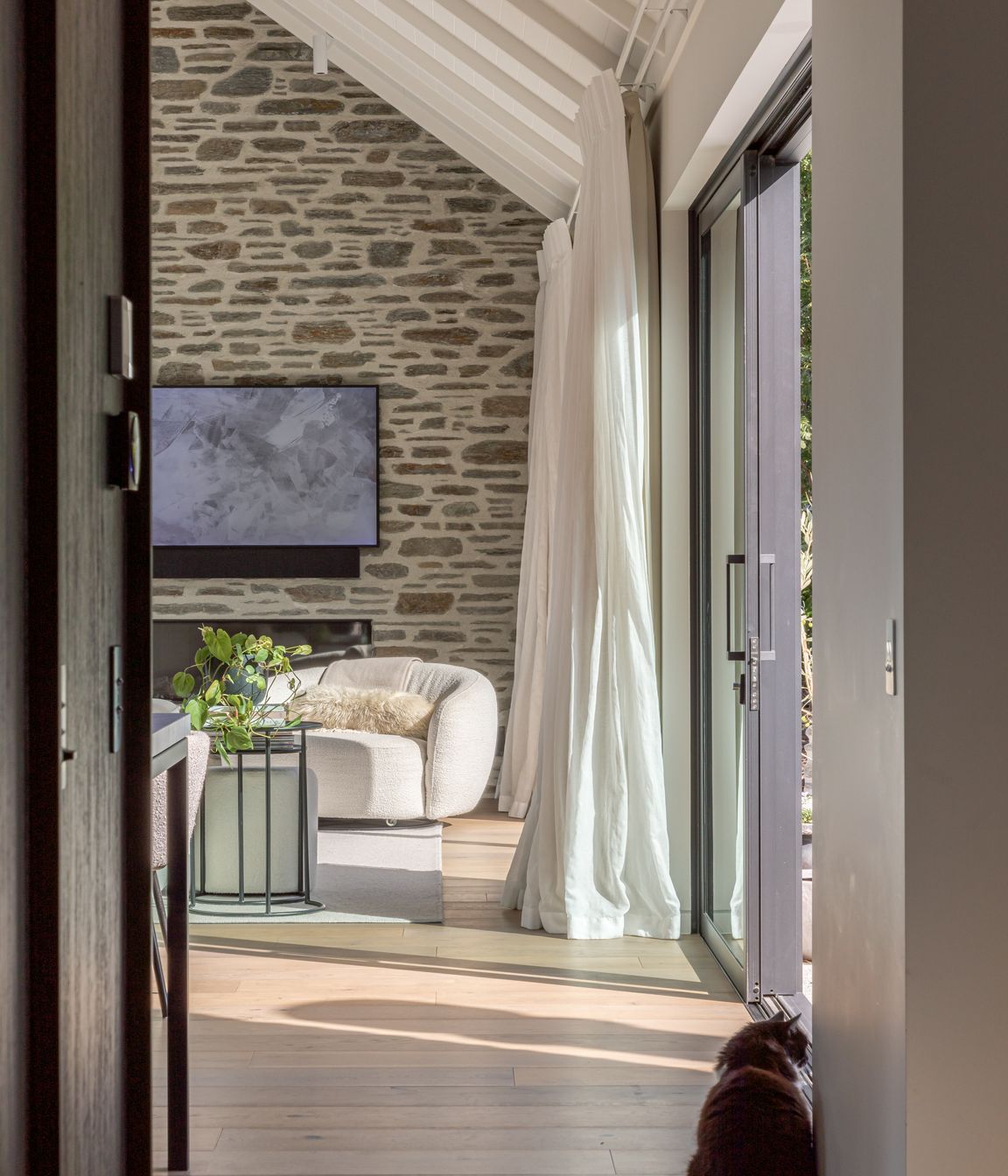 Schist stone ant timber plank flooring add warmth and texture to the interior
