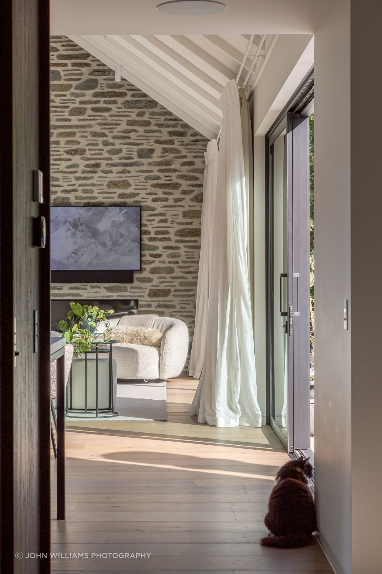 Schist stone ant timber plank flooring add warmth and texture to the interior