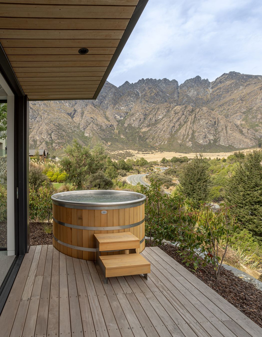 Master bedroom and ensuite both open to a secluded private deck and spa with epic mountain views