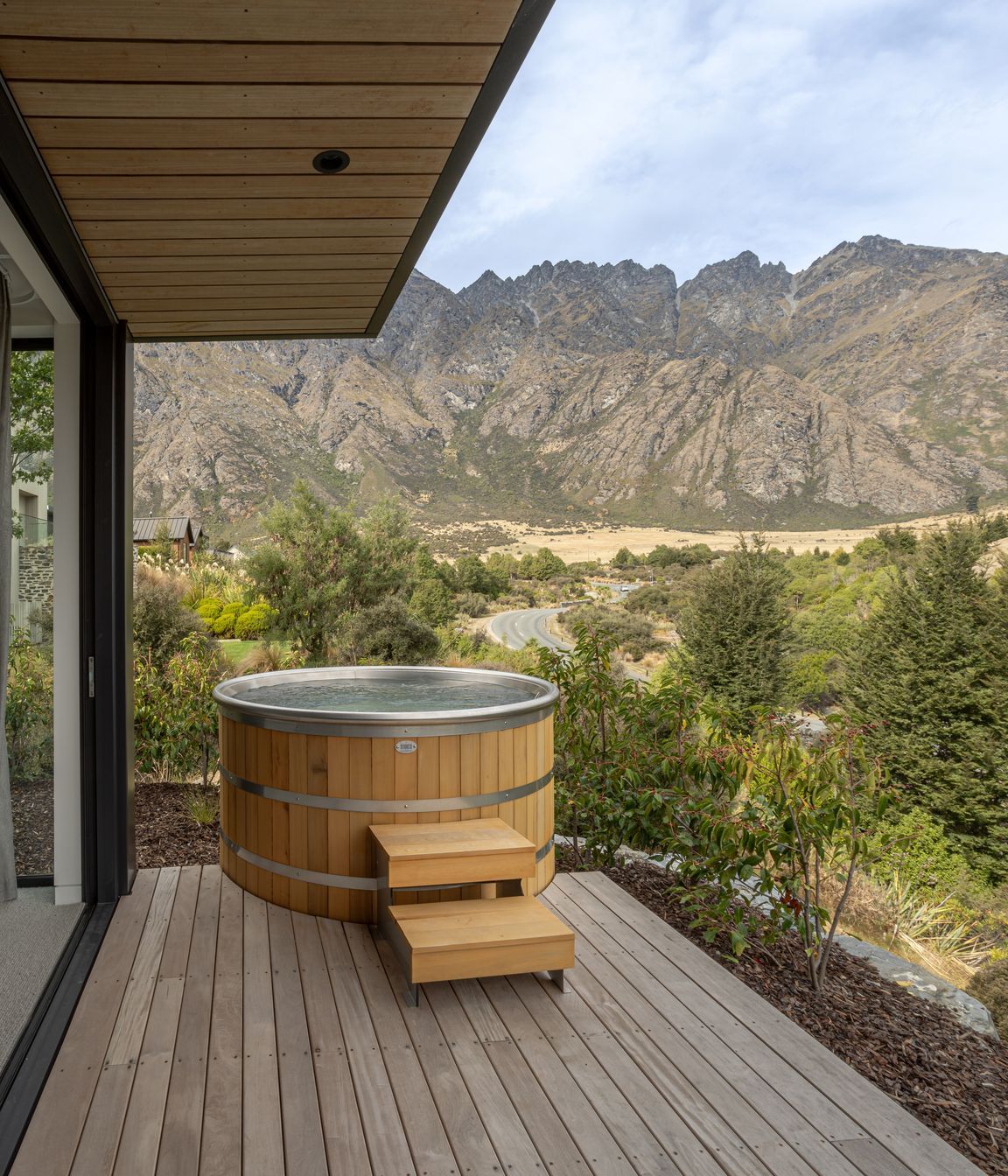Master bedroom and ensuite both open to a secluded private deck and spa with epic mountain views