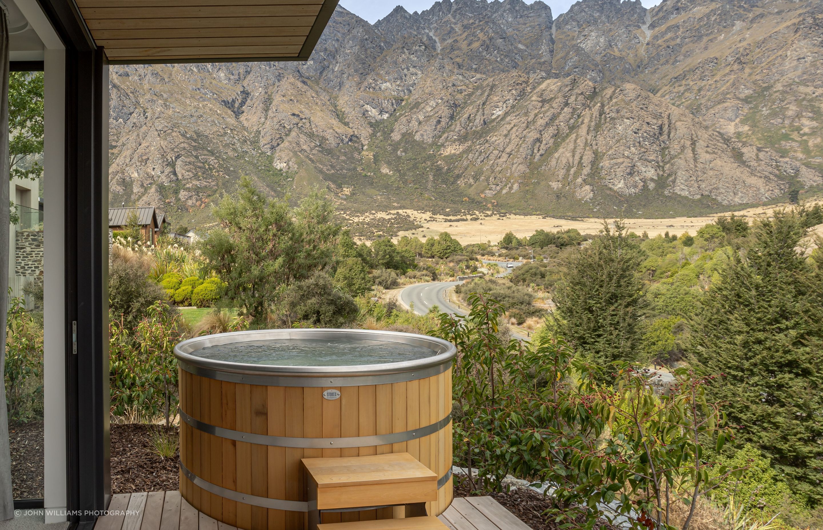 Master bedroom and ensuite both open to a secluded private deck and spa with epic mountain views