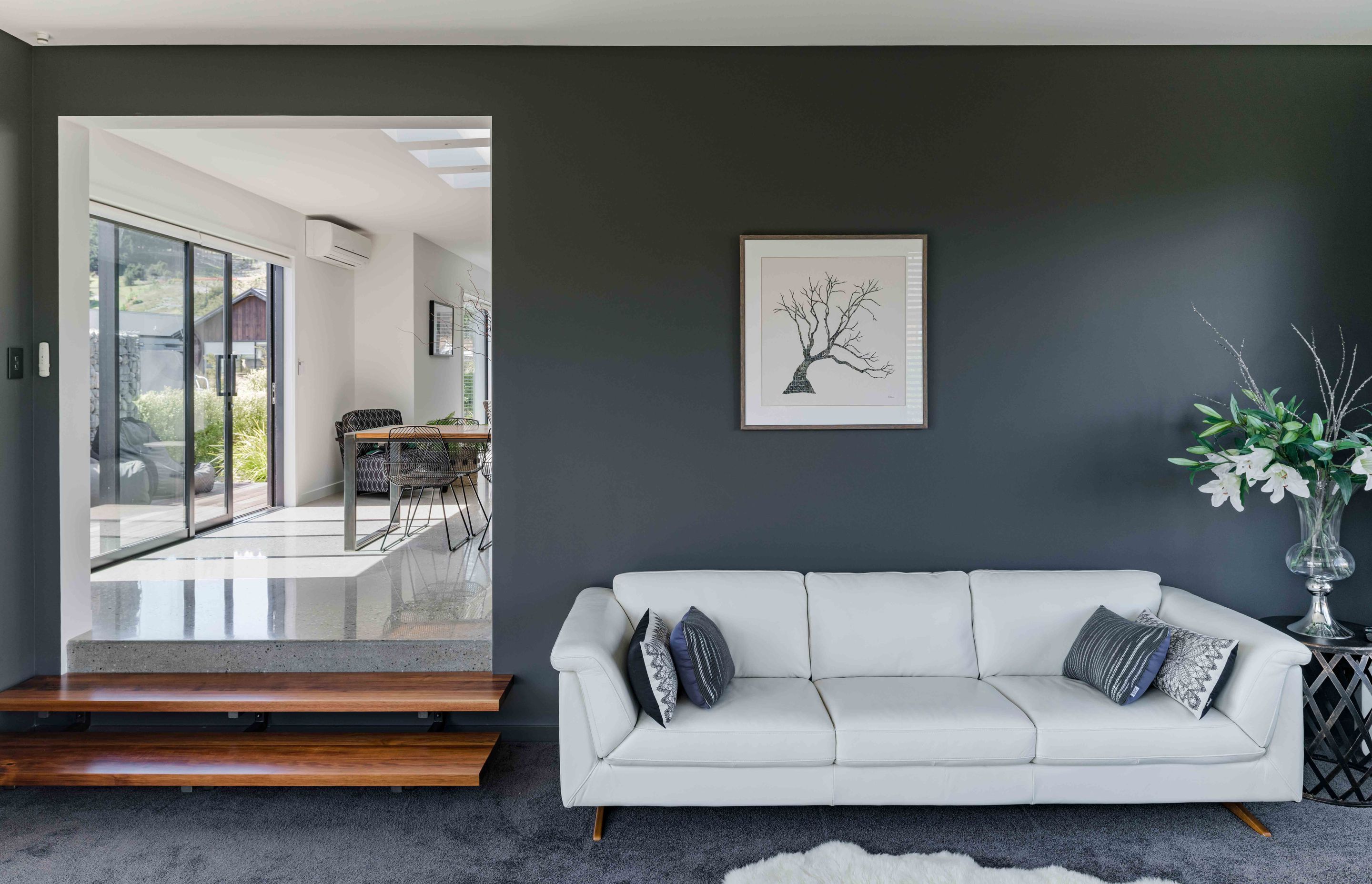 Dulux 'Castlecliff', a grey with a warm undertone, makes the living room more intimate whereas elsewhere the walls are painted Dulux 'Mt Aspiring'.