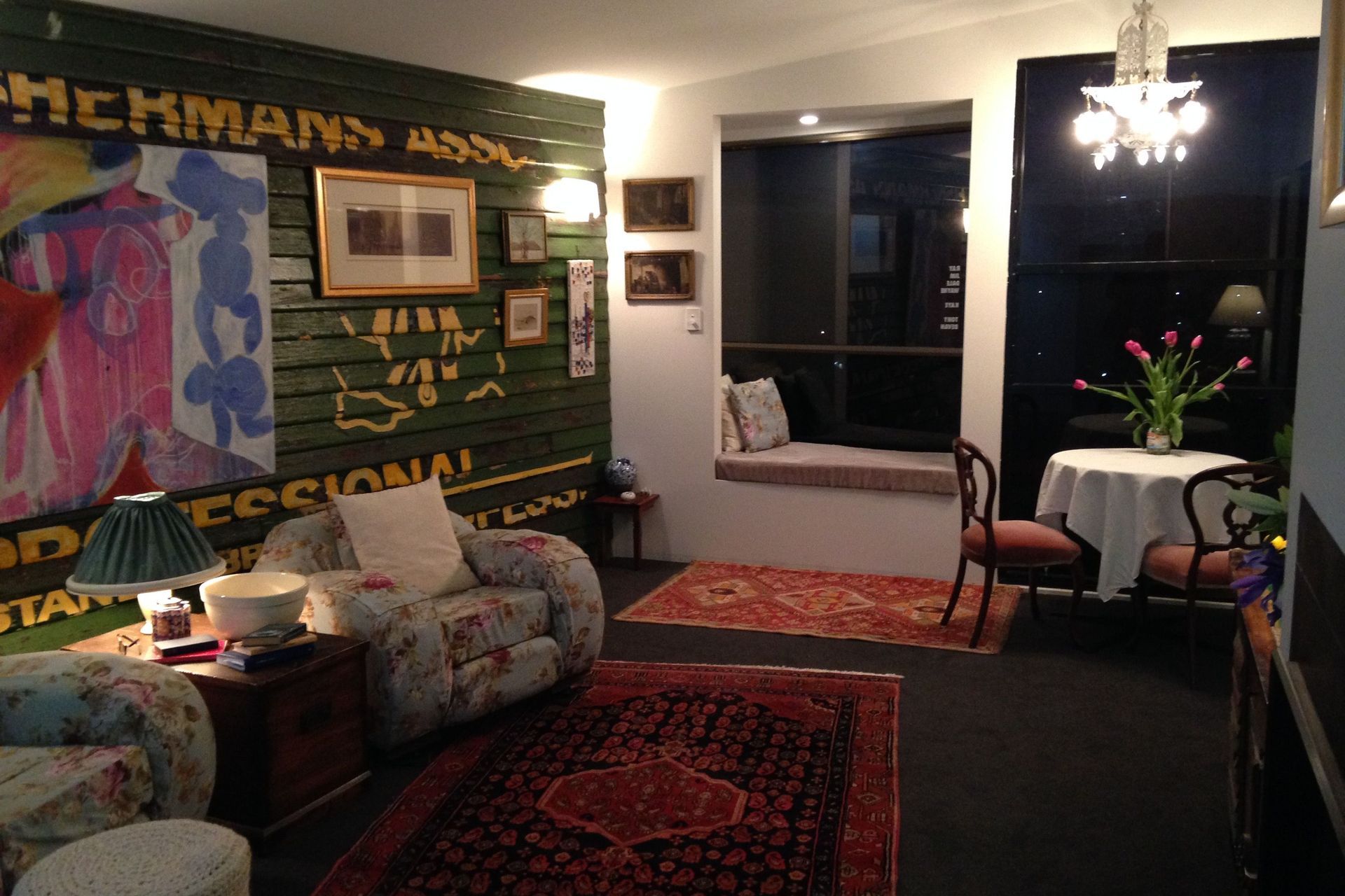 Carpeted flooring, 100% wool gives the room real warmth and comfort. Recycled weatherboards are from the demolished North Western Tasmanian Fishermans Association building. Recycled commercial windows still show the names of the workers (the client decided to remove their mobile numbers). Bay window is a favourite spot. Clients own furniture is a mix of family antiques including the cast iron chandelier from his grandfathers family home in Queensland
