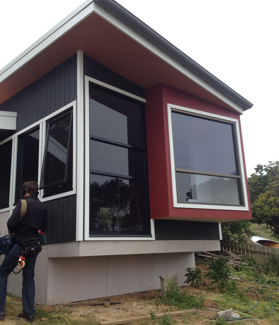 Materials are robust. Ecoply shadow clad v-joint board, with harries vero board (floor had to be enclosed for BAL requirements). Builder put the gutter on the front of the cottage, without instruction, between site visits. Colours are taken from the landscape-charcoal of the basalt of The Nut, red for the iron rich soil